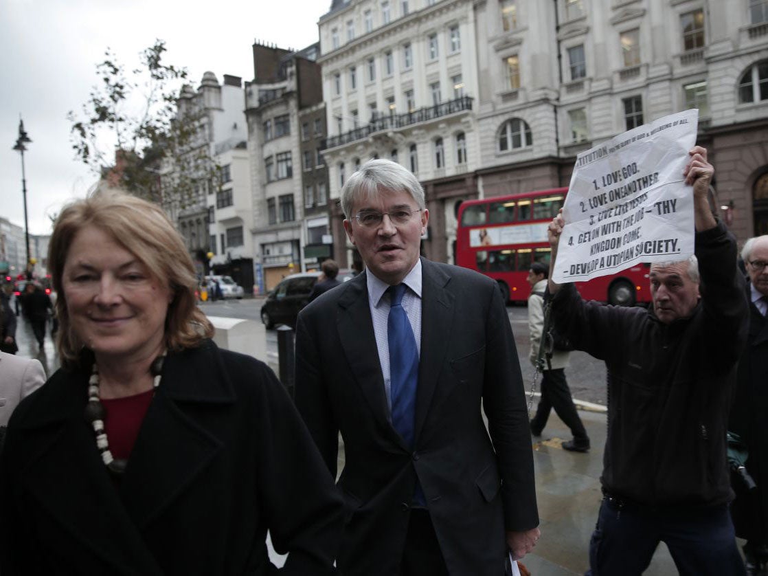 Andrew Mitchell, accompanied by his wife Sharon, arrives at the Royal Courts of Justice in London this week (AP)