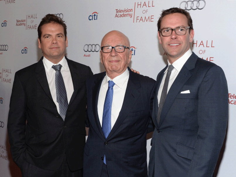 James Murdoch, right, with his father Rupert and brother Lachlan, left