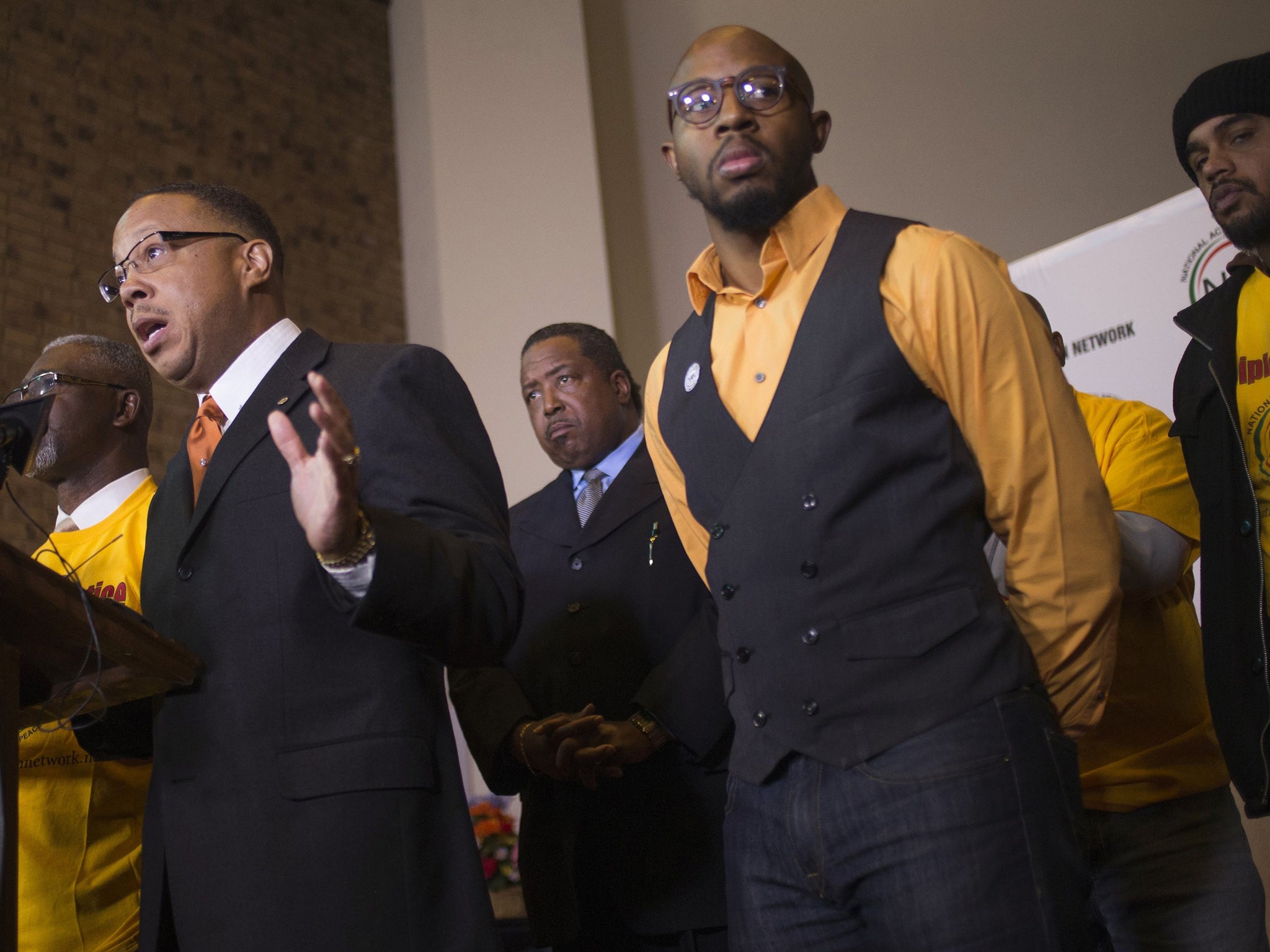 Michael Brown's family attorney Anthony Gray (L) speaks during an announcement for Justice Disciple volunteers