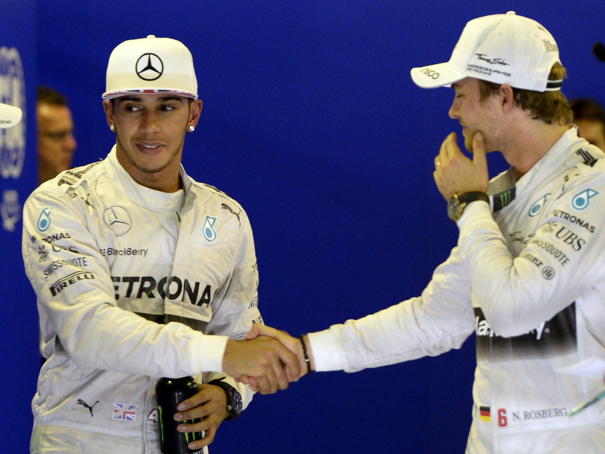 Lewis Hamilton shakes hands with Nico Rosberg as the two share a smile