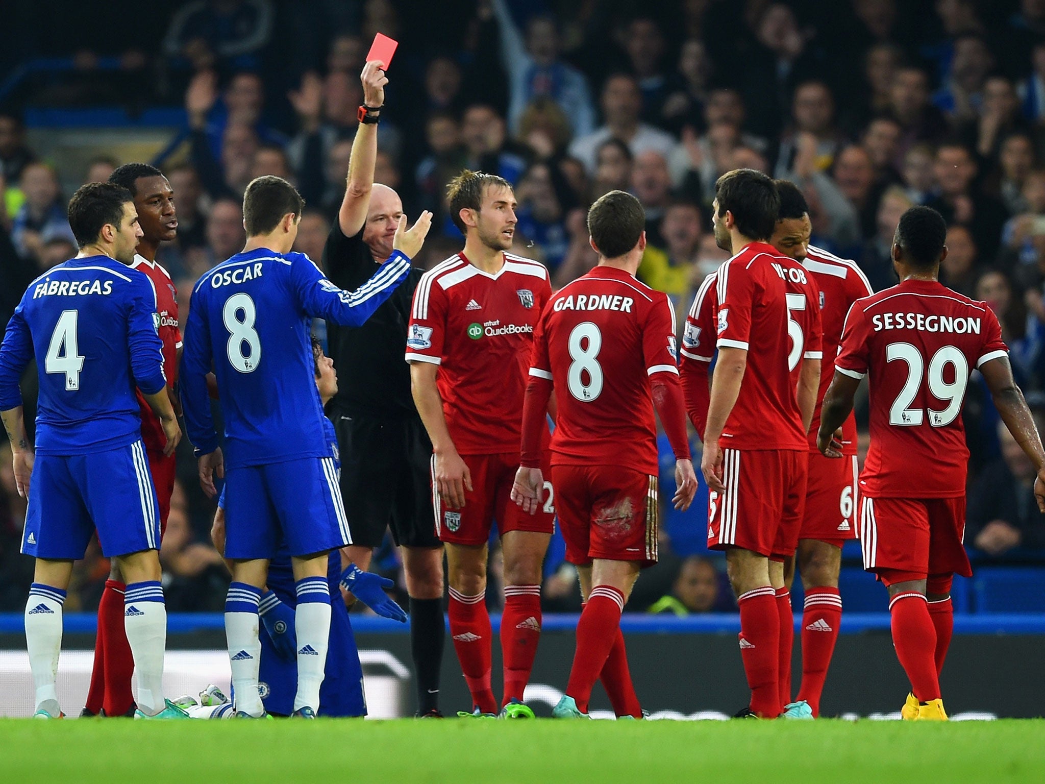 Lee Mason shows Claudio Yacob the red card for a two-footed tackle