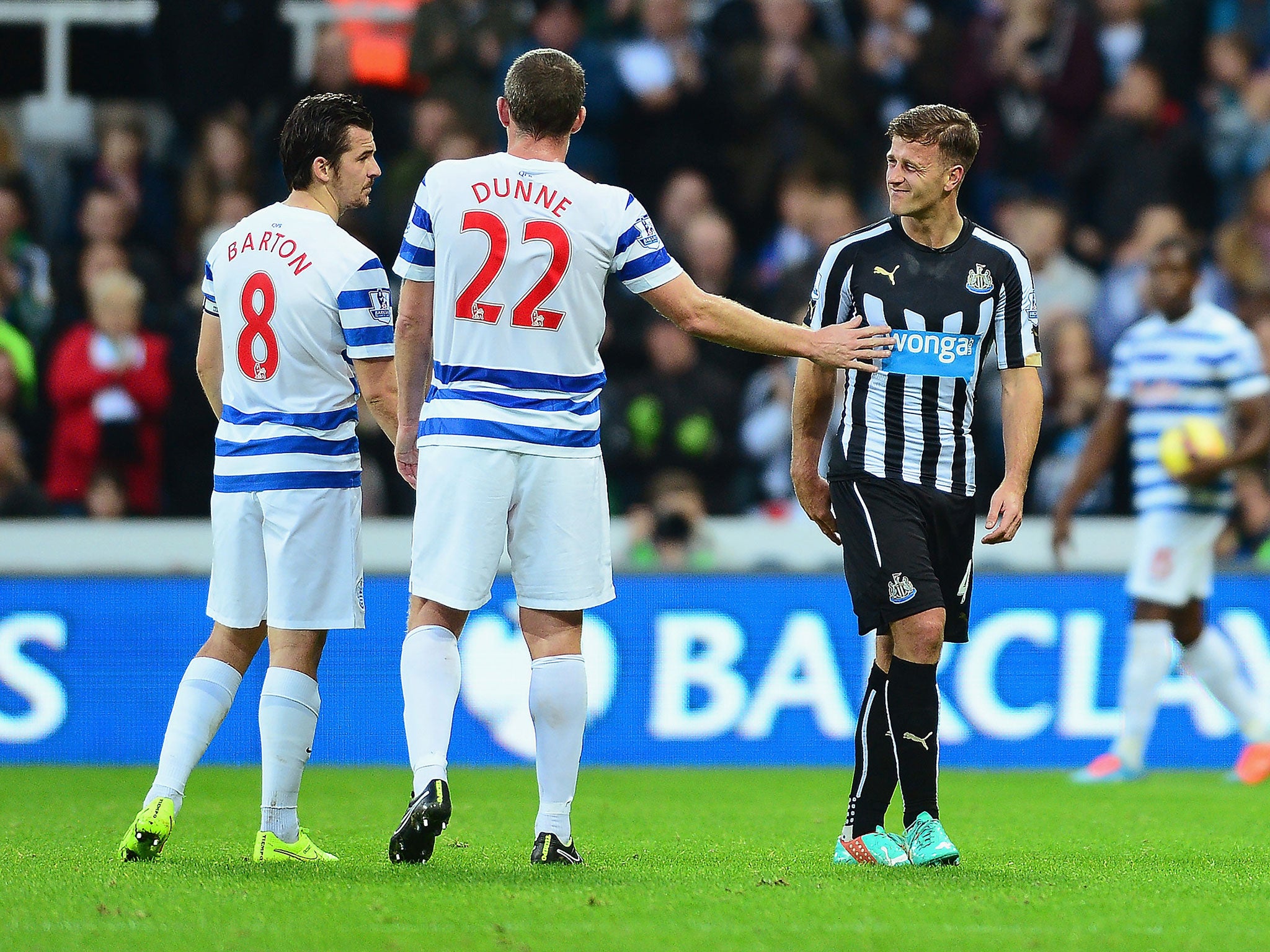 Joey Barton and Richard Dunne of QPR console Newcastle's Ryan Taylor
