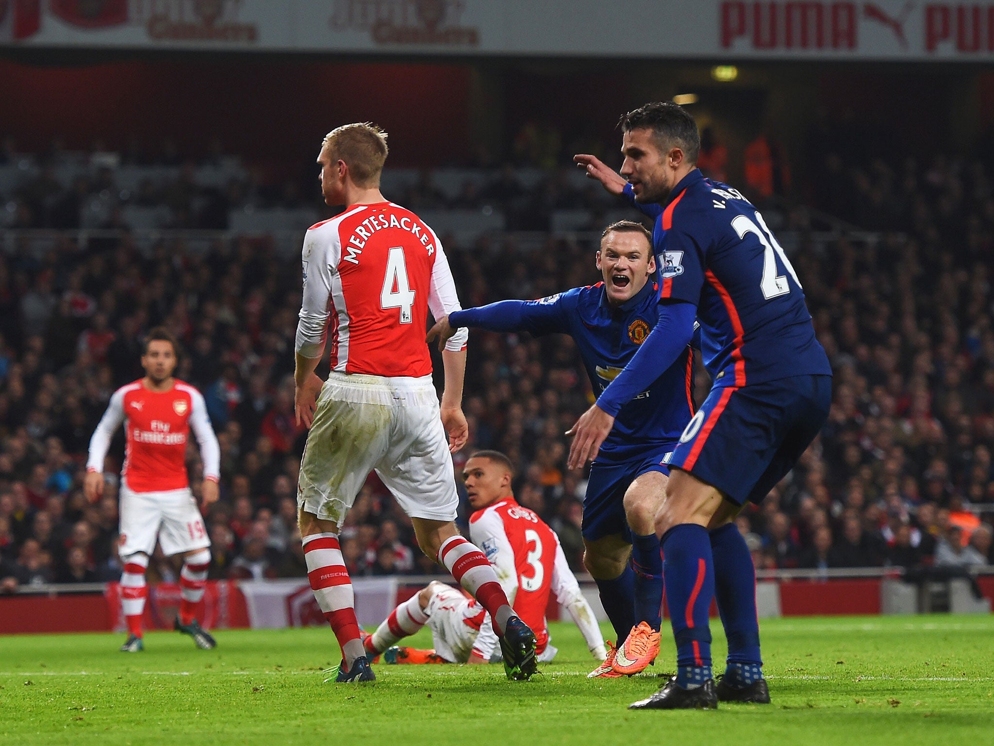 Kieran Gibbs watches as he deflects into his own net