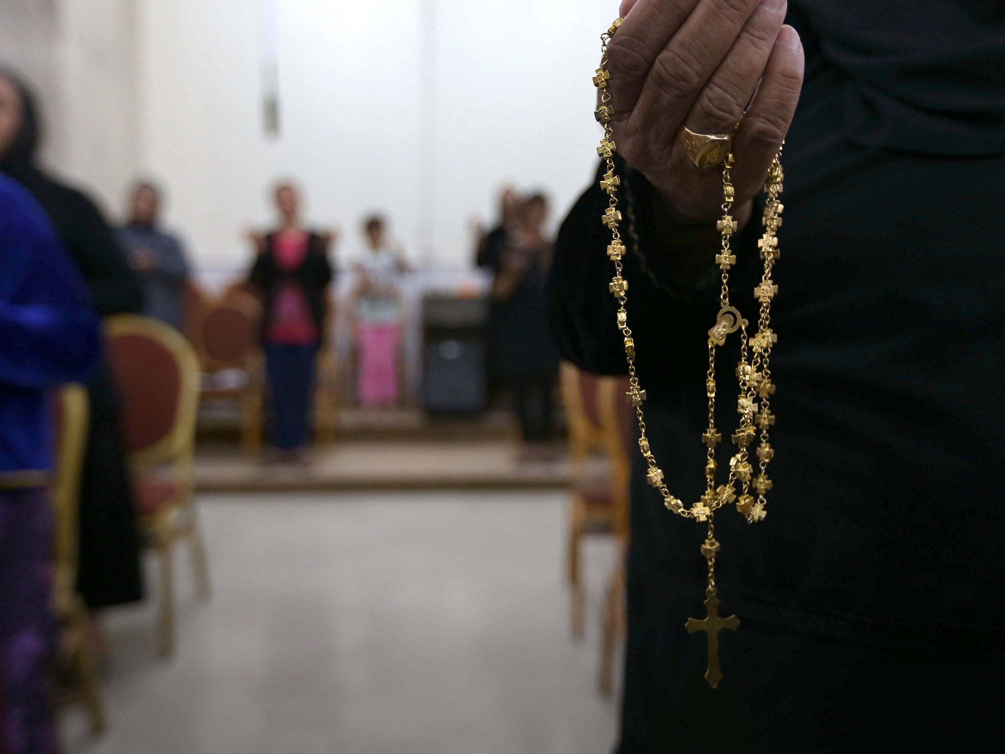Christians who fled Mosul pray at a church in Qaraqosh