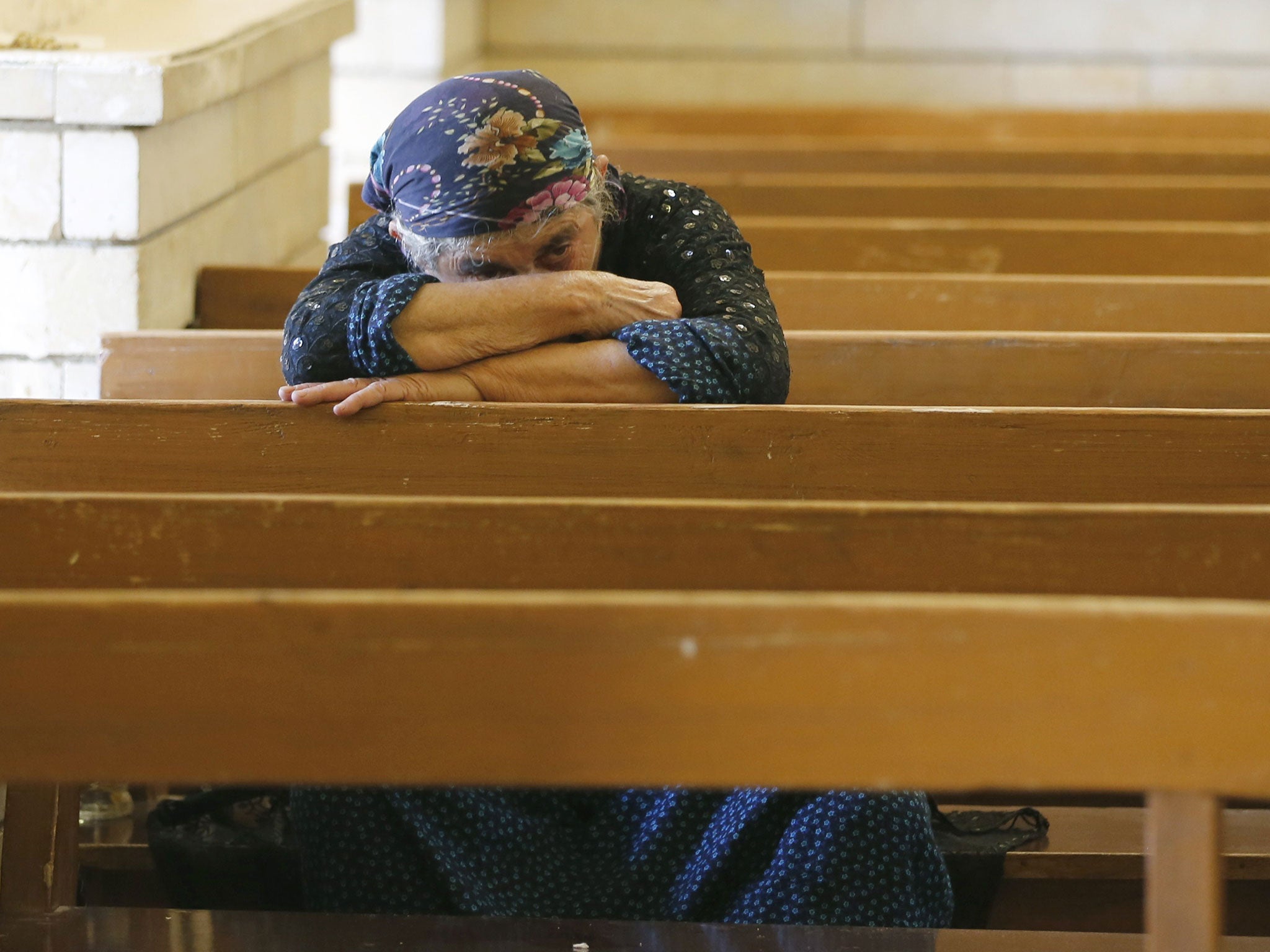 A Christian refugee prays in Irbil