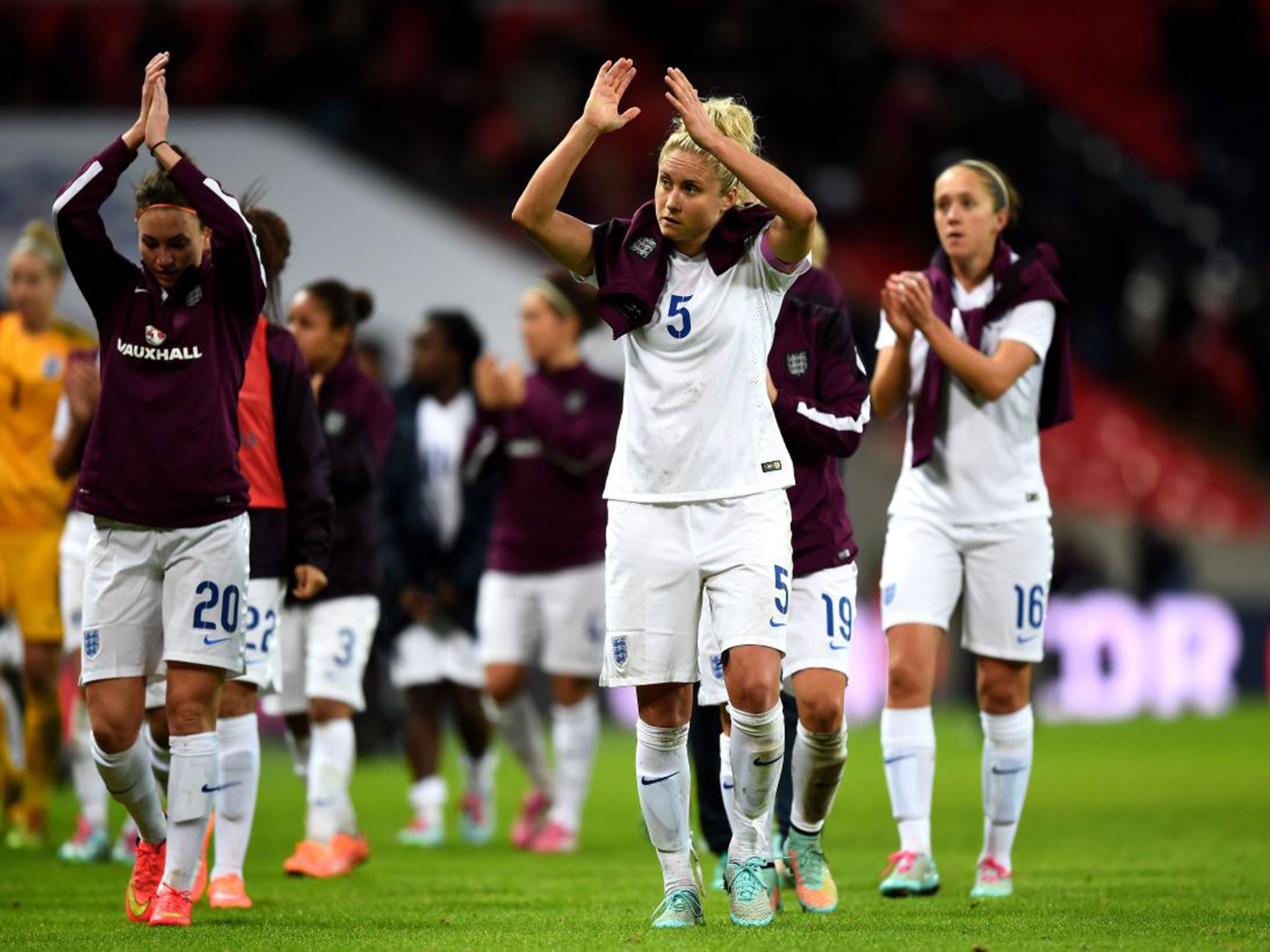Dejected England players applaud the fans following their team's 3-0 defeat