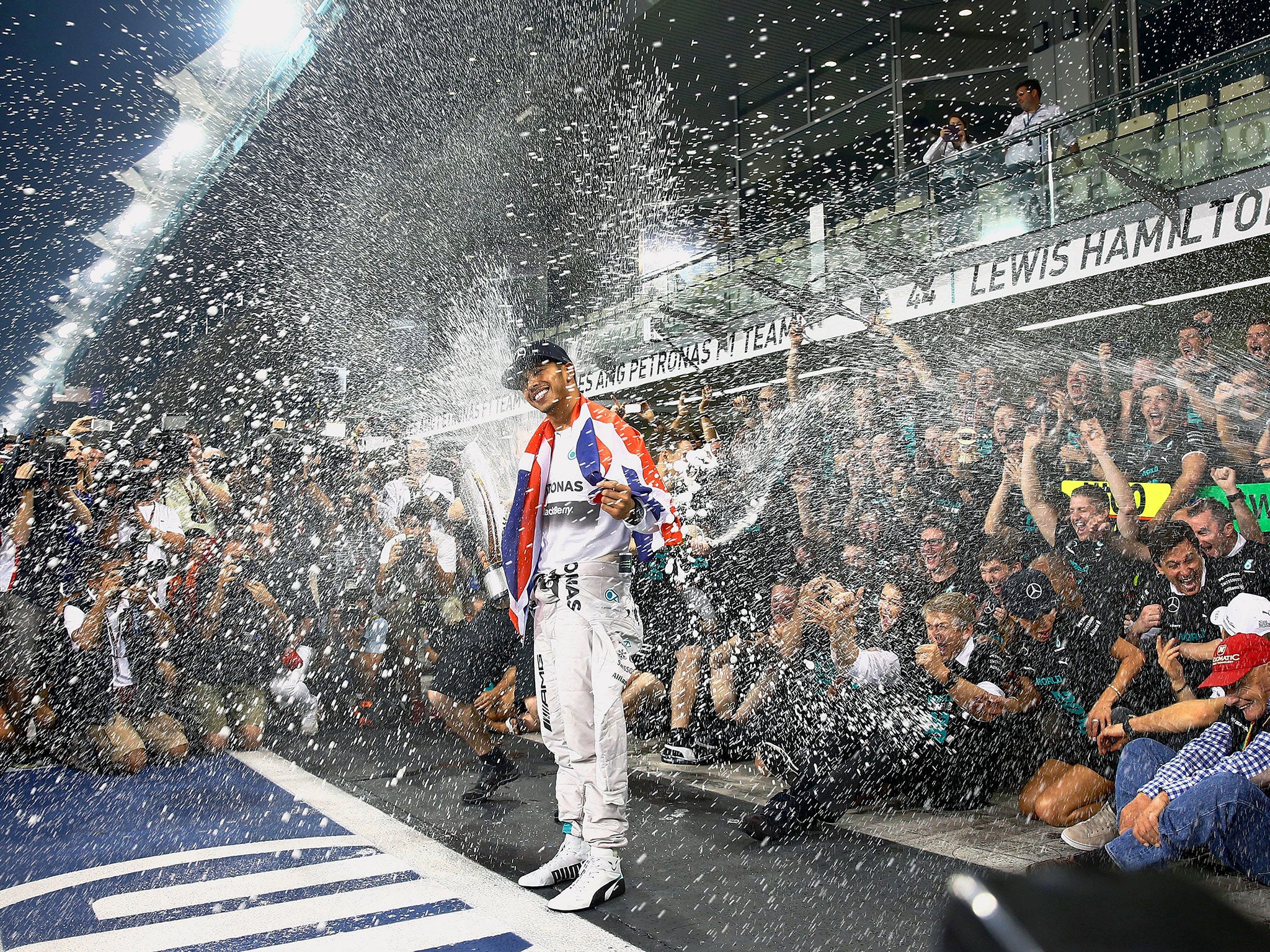 Lewis Hamilton is showered with champagne after the race