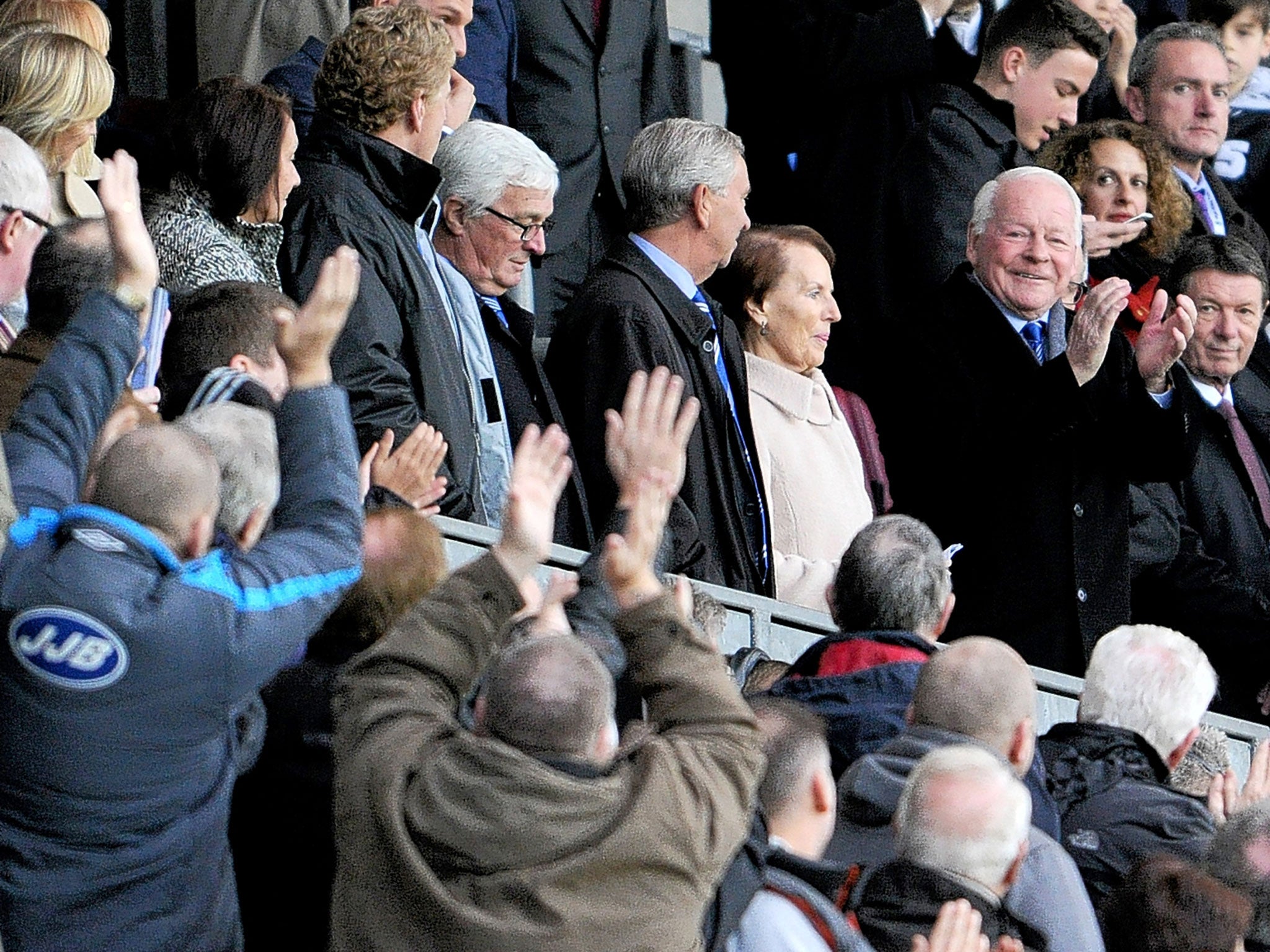 The Wigan Athletic chairman, Dave Whelan, returns the applause of fans as he takes his seat at the DW Stadium on Saturday