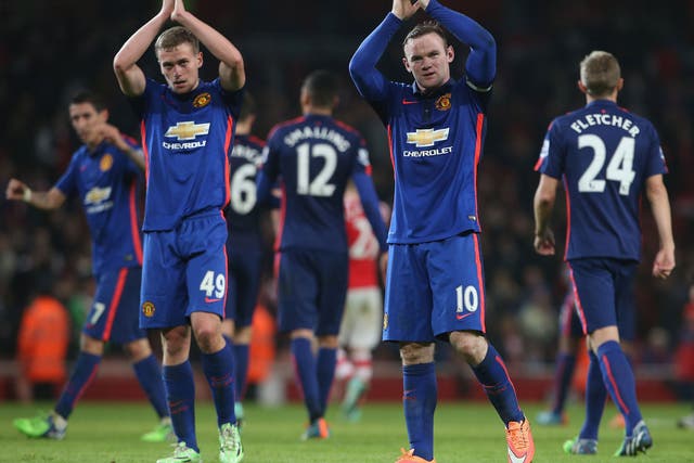 Wayne Rooney and James Wilson applaud the travelling Manchester United fans