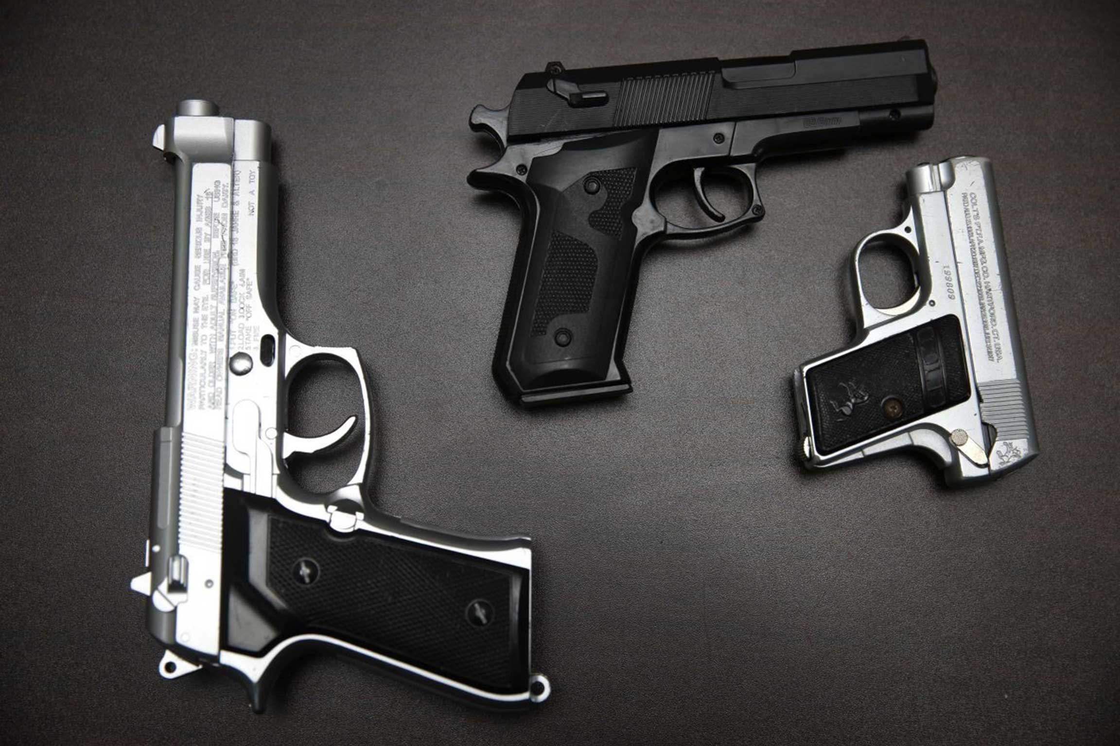 Fake guns are displayed with other prohibited carry-on items during a news conference