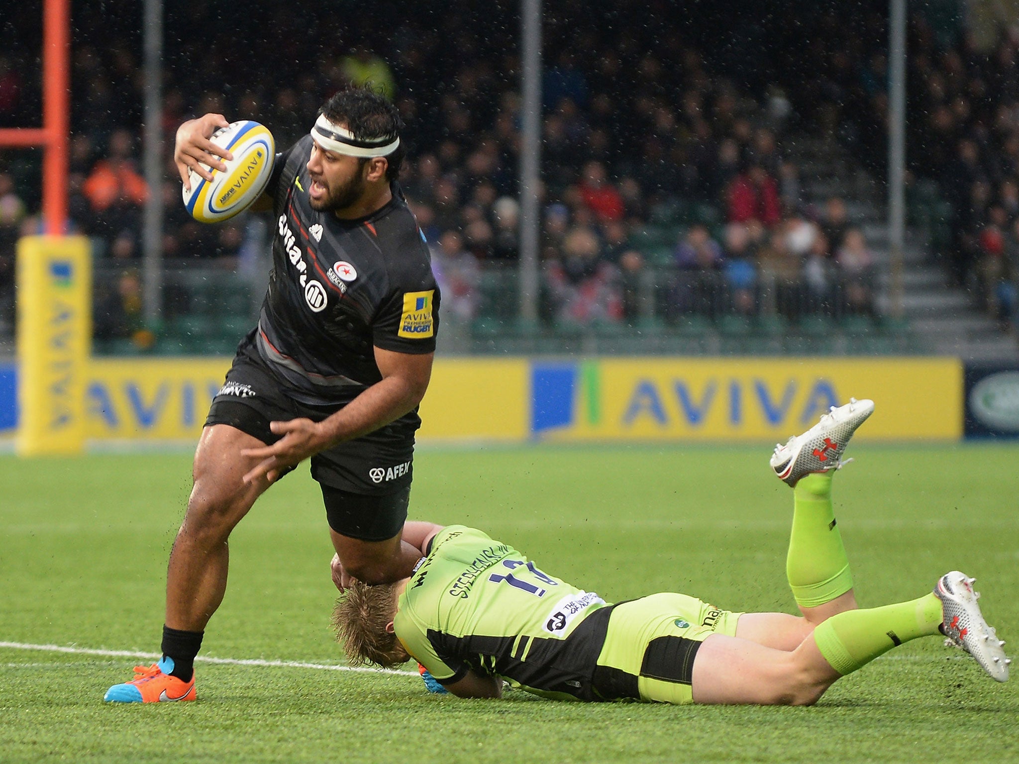 Billy Vunipola is tackles by Tom Stephenson