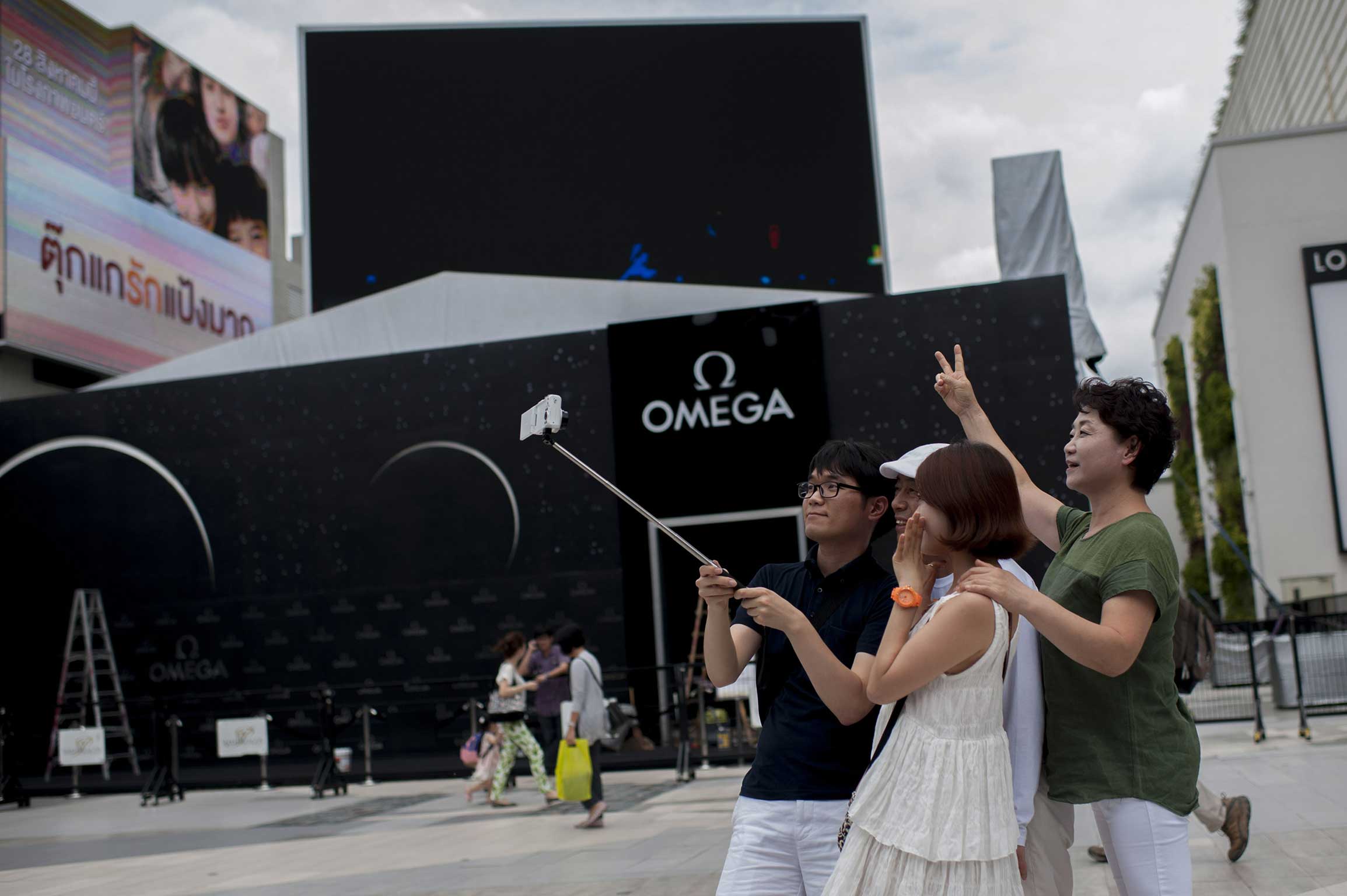 Tourists in Bangkok use a selfie stick