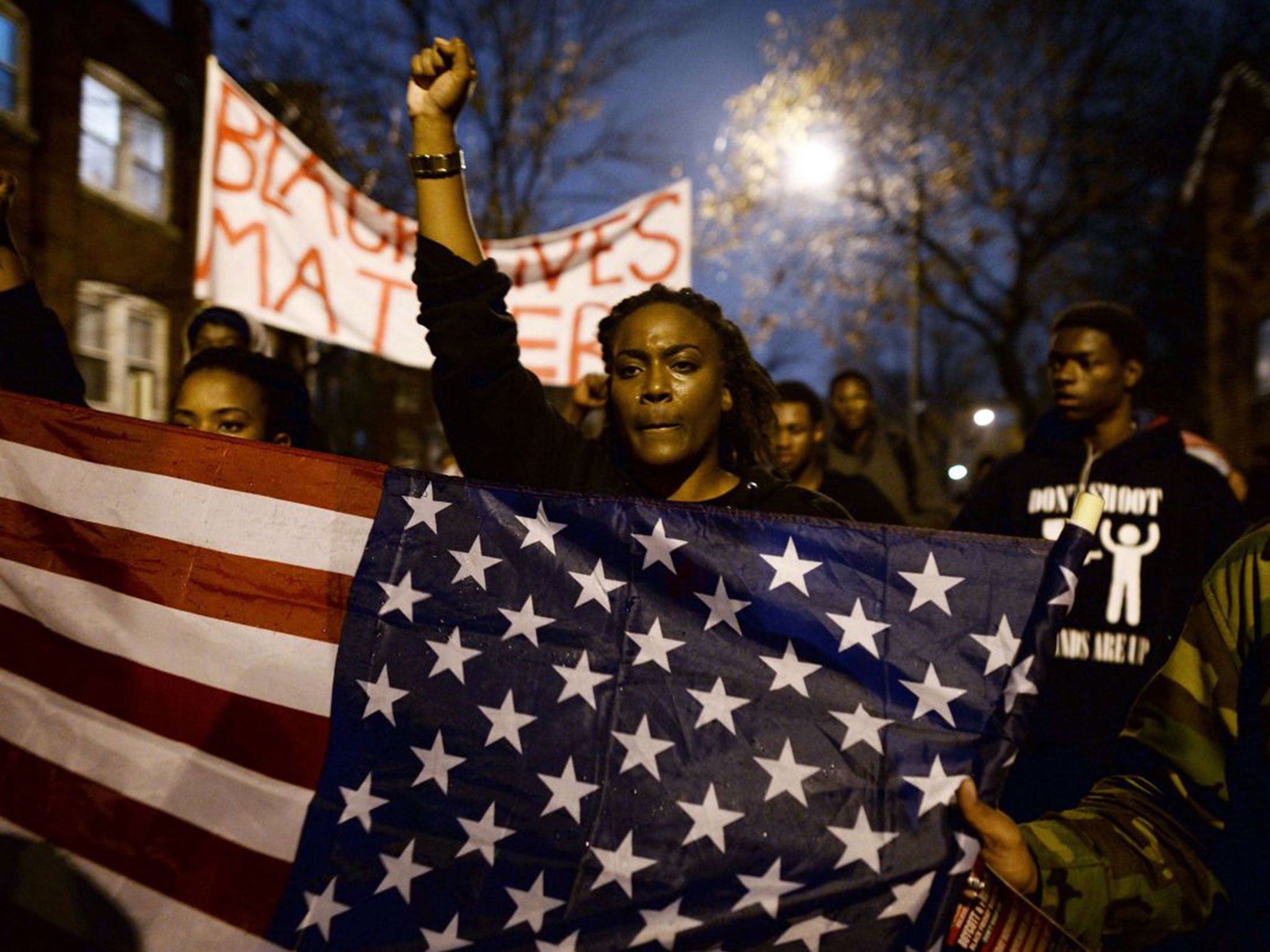 Protesters march in St Louis, Missouri, to put pressure on the grand jury to charge Officer Darren Wilson over the killing of Michael Brown