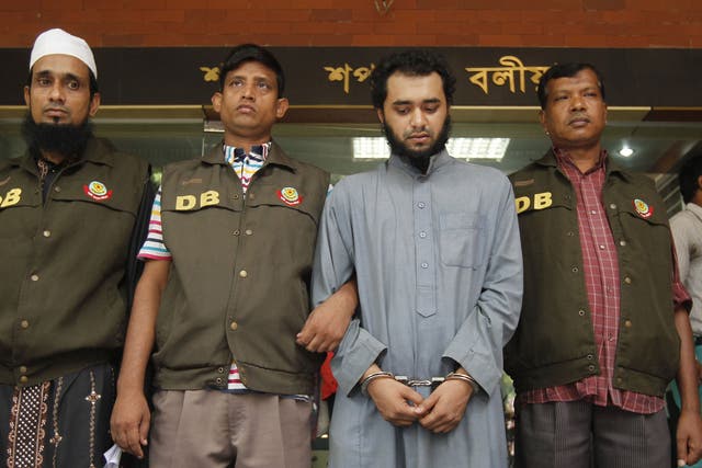 Samiun Rahman, centre, was re-arrested at a train station for the media’s benefit, according to a human rights group