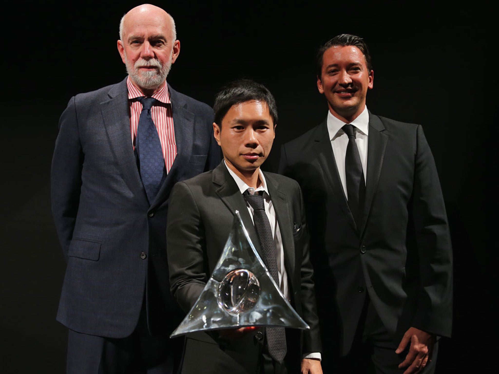 Hugo Boss Prize winner Paul Chan (centre) holds the tetrahedral trophy, alongside Solomon R Guggenheim Museum and Foundation director Richard Armstrong (left) and Hugo Boss Americas CEO and president Gerrit Rützel