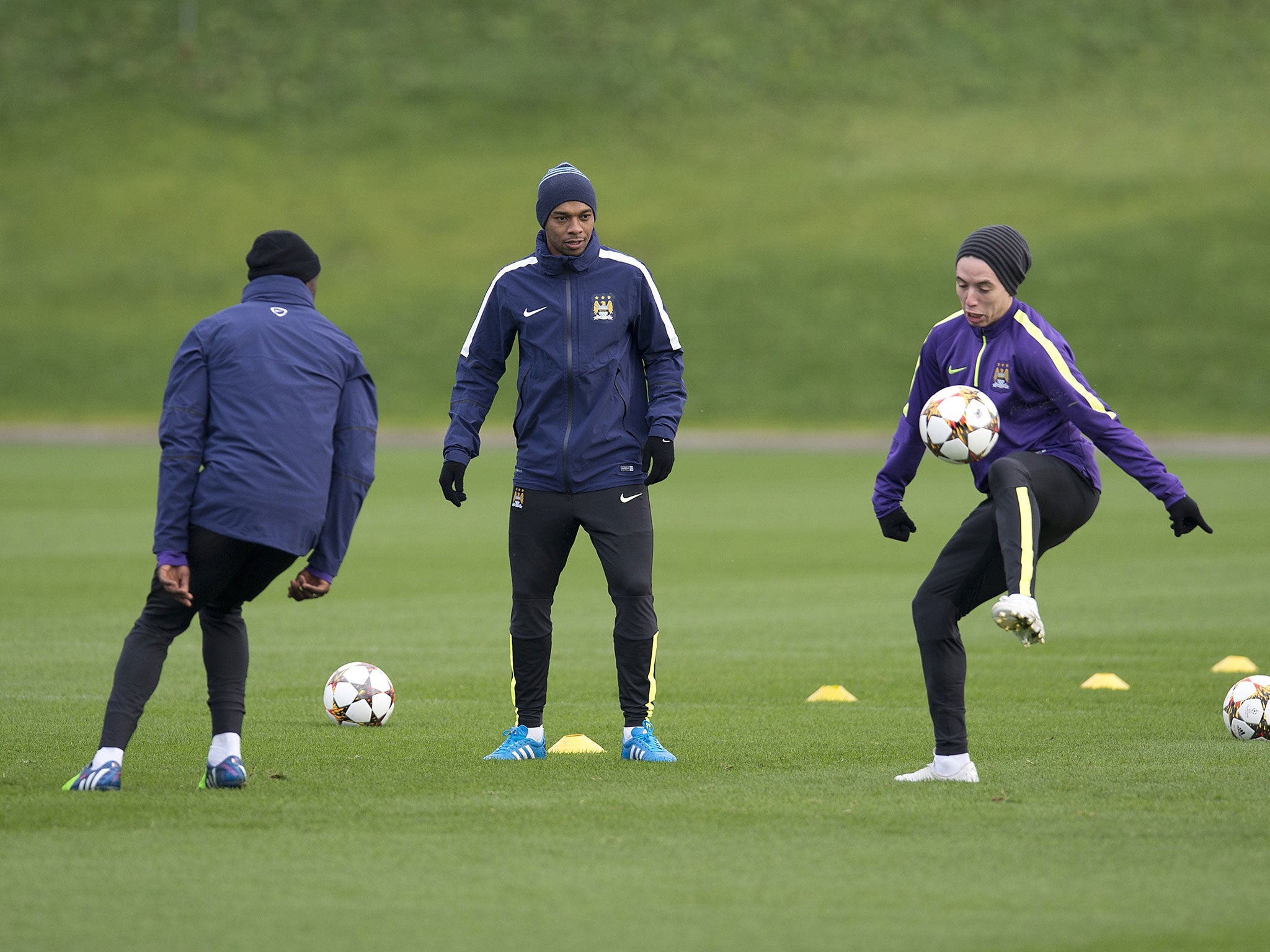 Brazilian midfielder Fernandinho, centre, and Frenchman Samir Nasri, right, take part in a team training session
