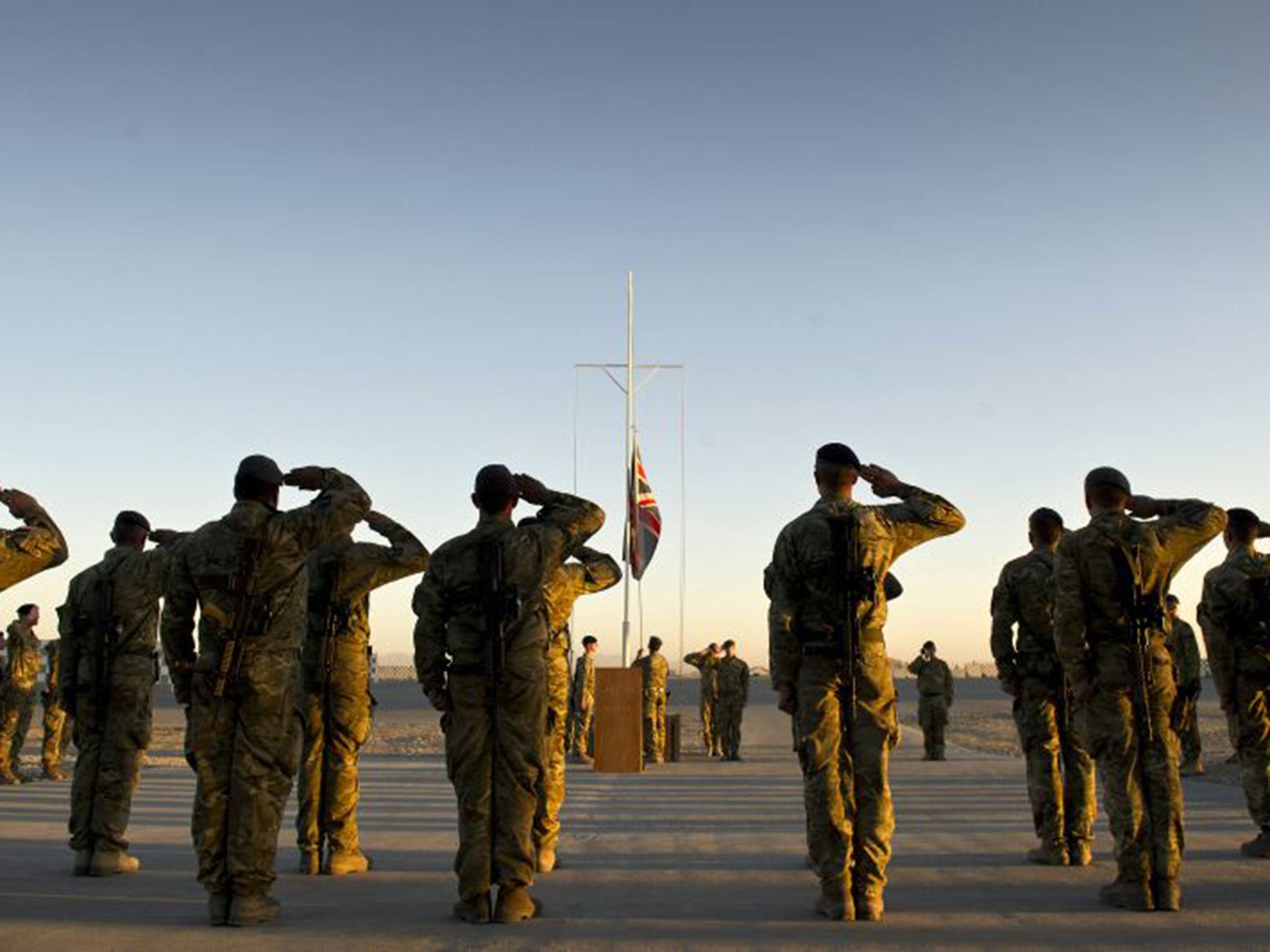 Garrison Sergeant Major, Andrew Stephens, lowers the Union flag for the last time at Kandahar Air base