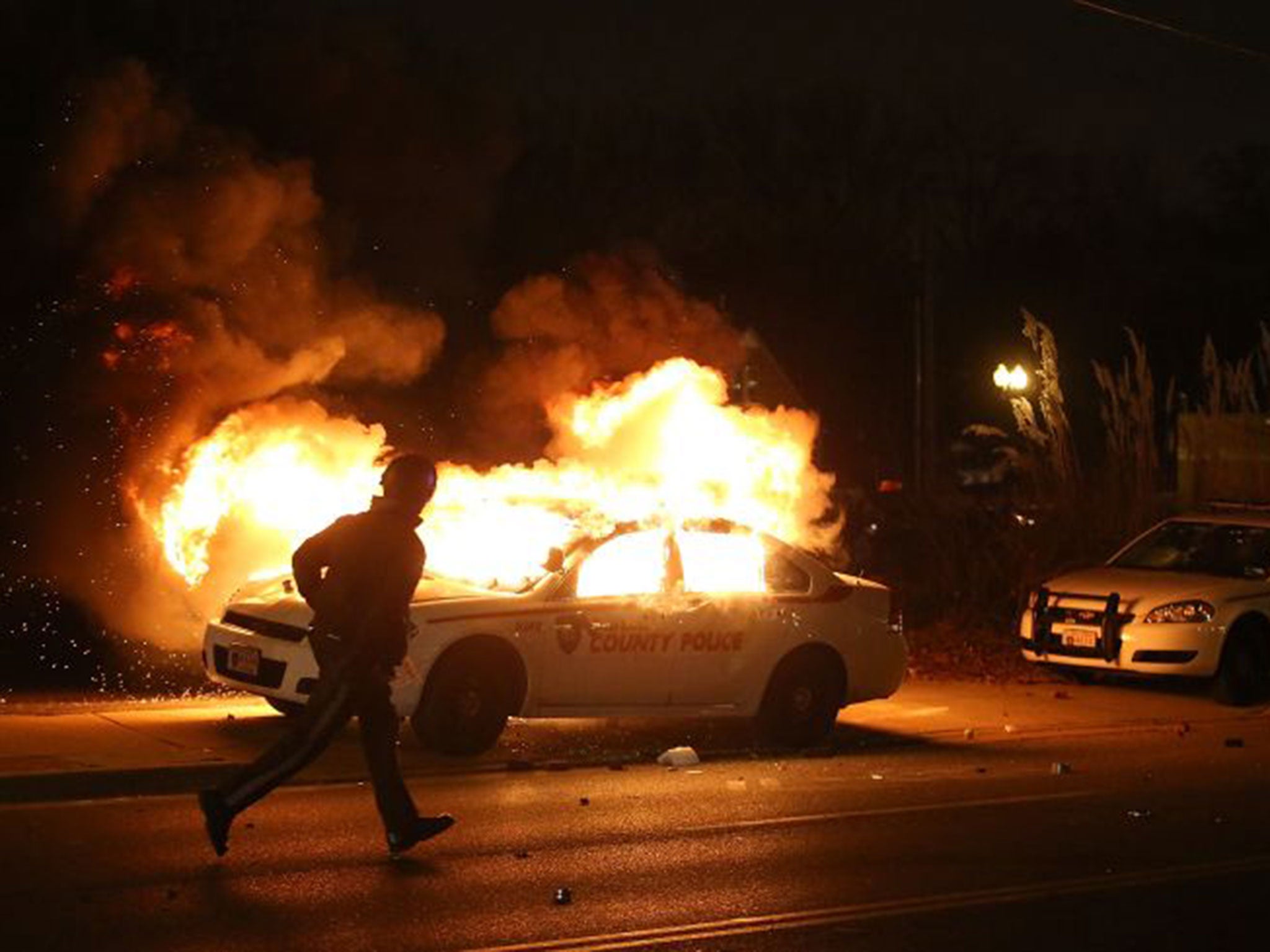 A car burns on the street after a grand jury returned no indictment in the shooting of Michael Brown