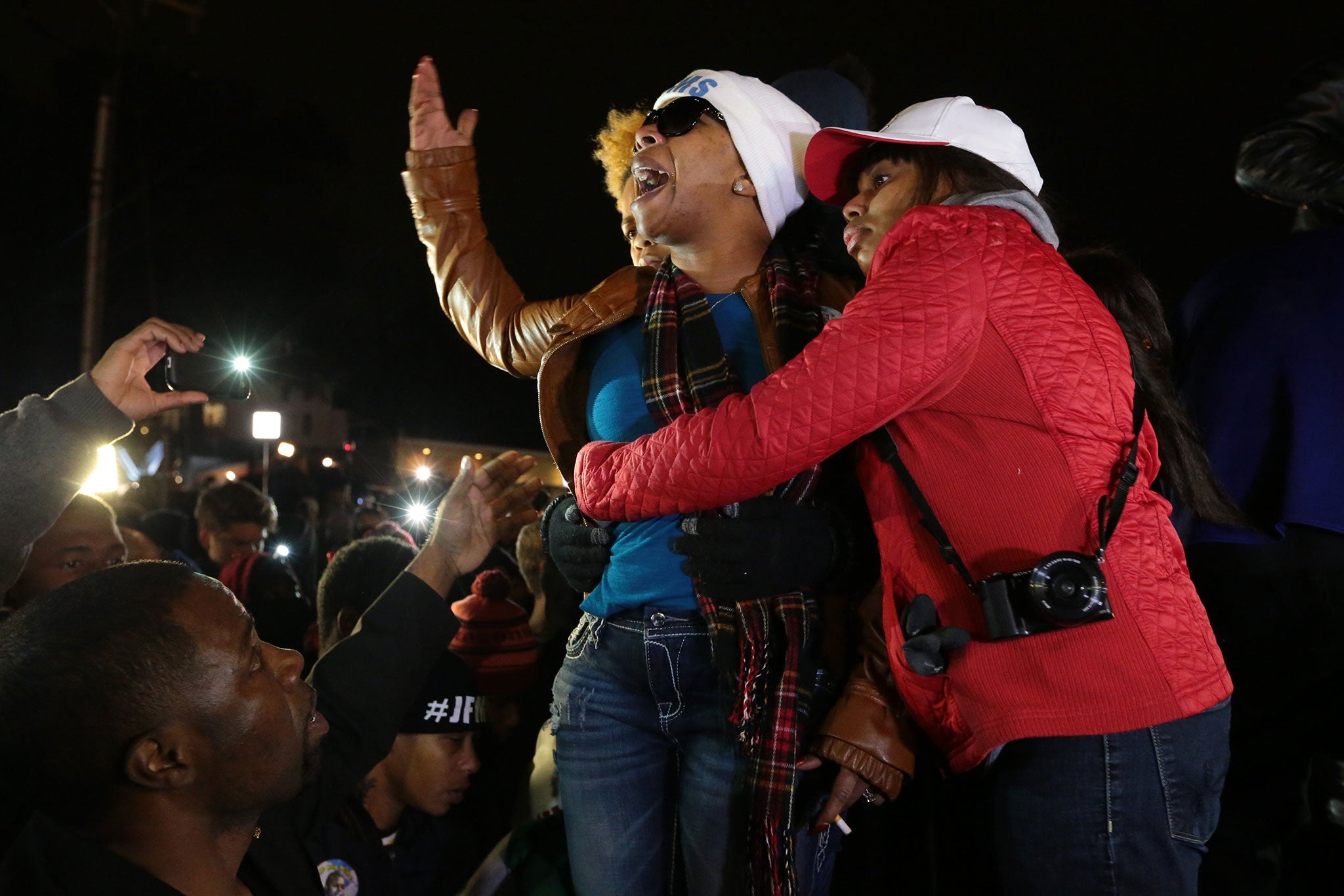 Lesley McSpadden, Michael Brown's mother, is comforted outside the Ferguson police department