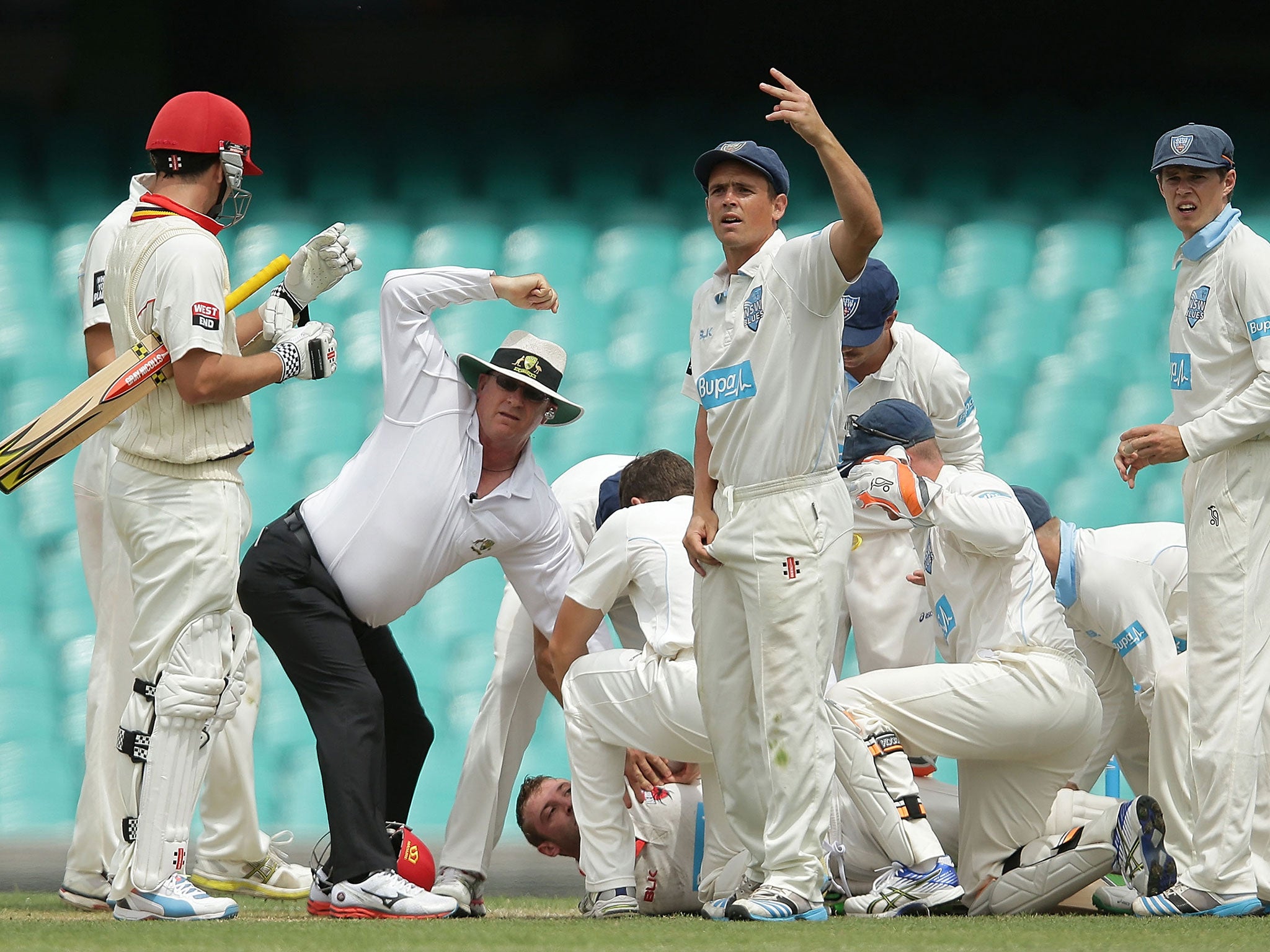 Players call for medical help after Hughes collapses