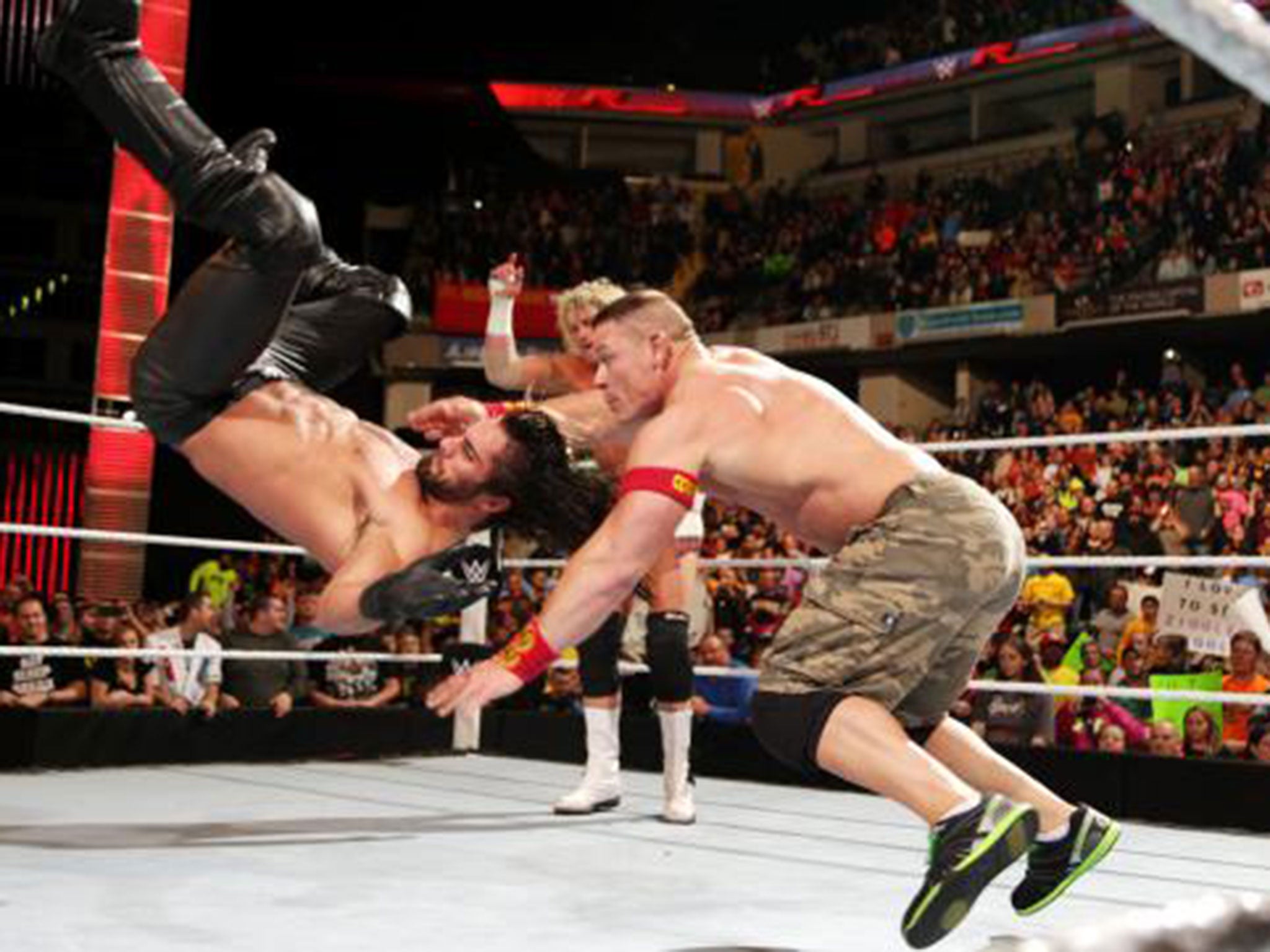 John Cena hits Seth Rollins with the Attitude Adjustment