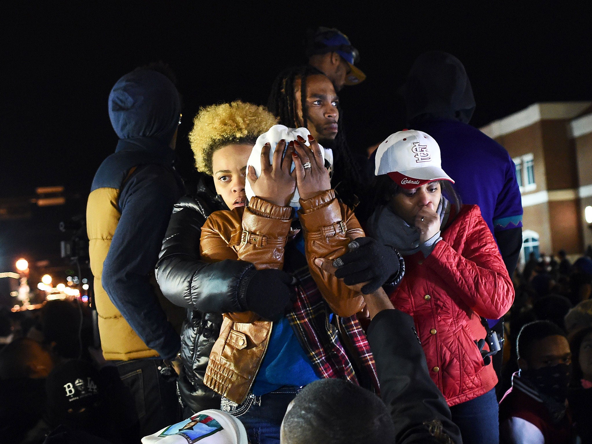 Michael Brown's mother Leslie McSpadden (C) and other protesters react after hearing the grand jury decision