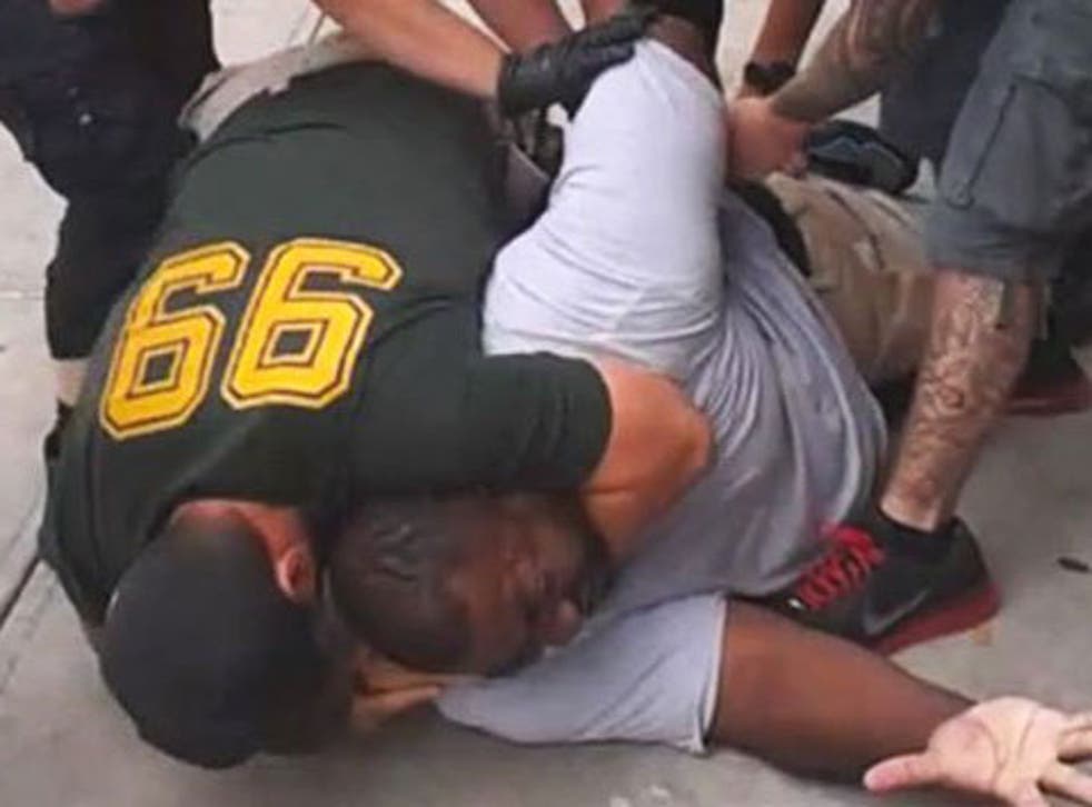 Eric Garner being held down by police officers while another puts him in a chokehold
