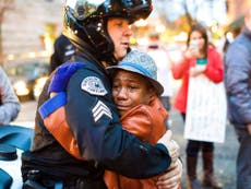 Crying boy's hug with police officer becomes one of the most shared images of Ferguson protests