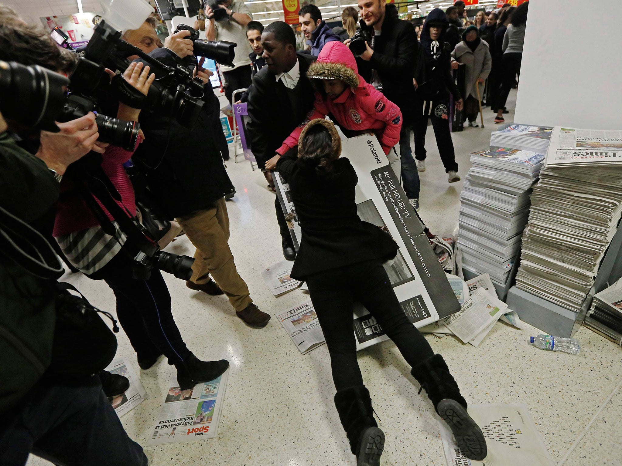 Shoppers wrestle over a television at an Asda superstore in Wembley