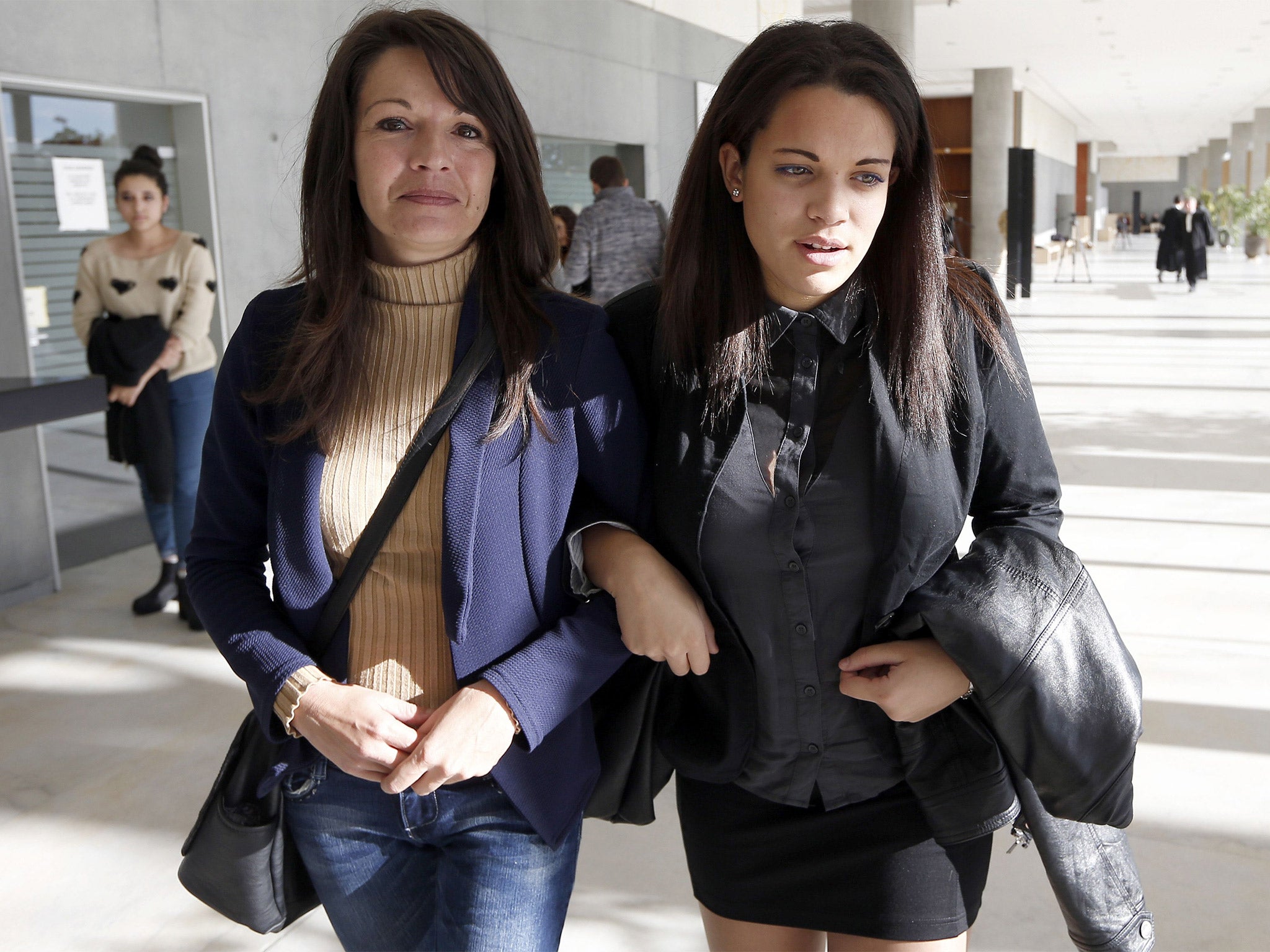 Sophie Serrano (left) and her daughter Manon Serrano leave court in Grasse, southern France, after a hearing for damages