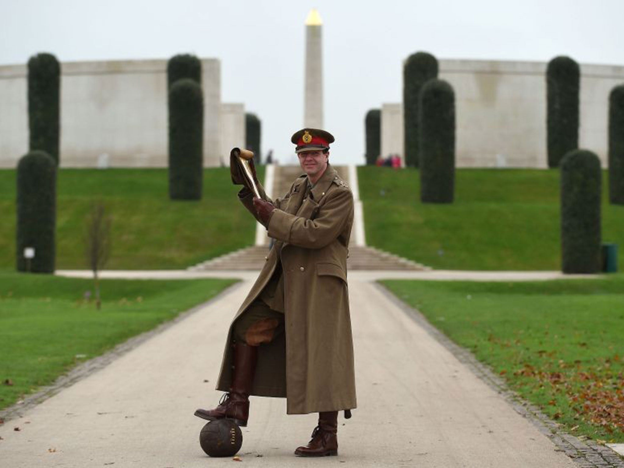 WW1 reenactor Paul Thompson, dressed in the uniform of a First World War General amongst the Shot at Dawn memorial at the National Memorial Arboretum in Alrewas, Staffordshire, reads a letter written by General Walter Congreve VC to his wife during the Fi