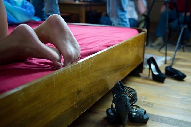 Two porn actresses' shoes lie at the side of a bed
