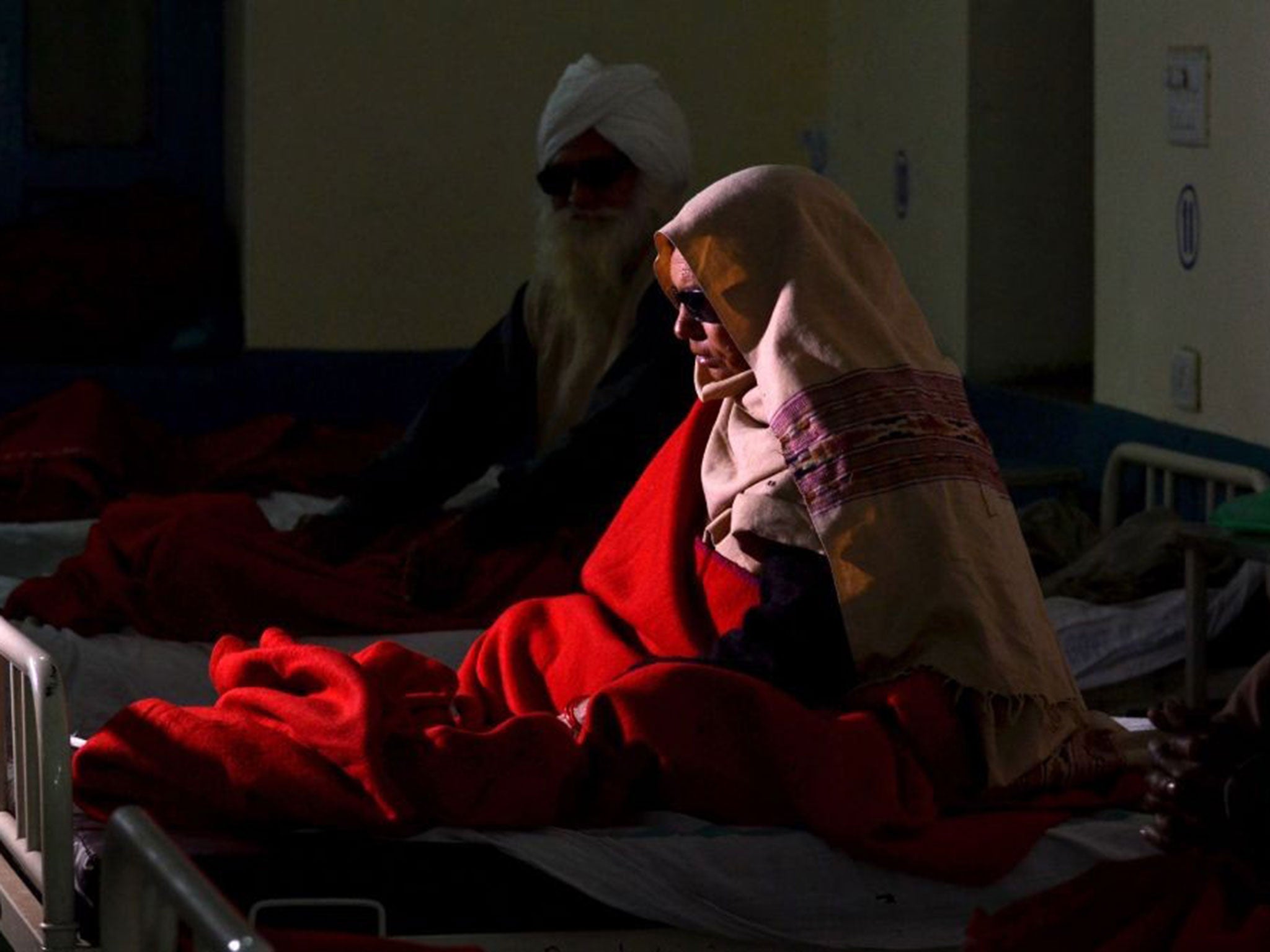 An elderly Indian patient who went blind following cataract surgery receives treatment at a hospital in Amritsar, India