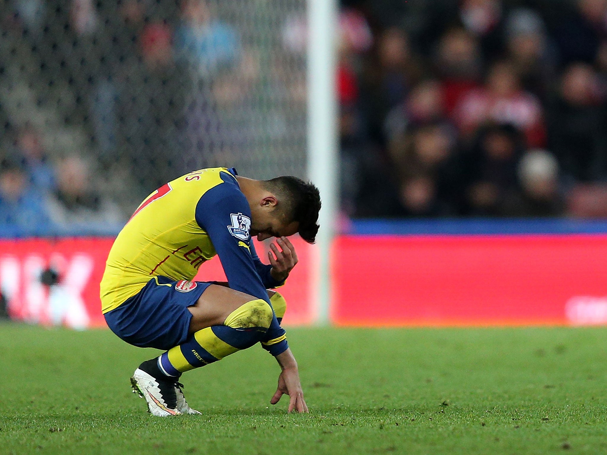 Alexis Sanchez holds his head after the 3-2 defeat to Stoke
