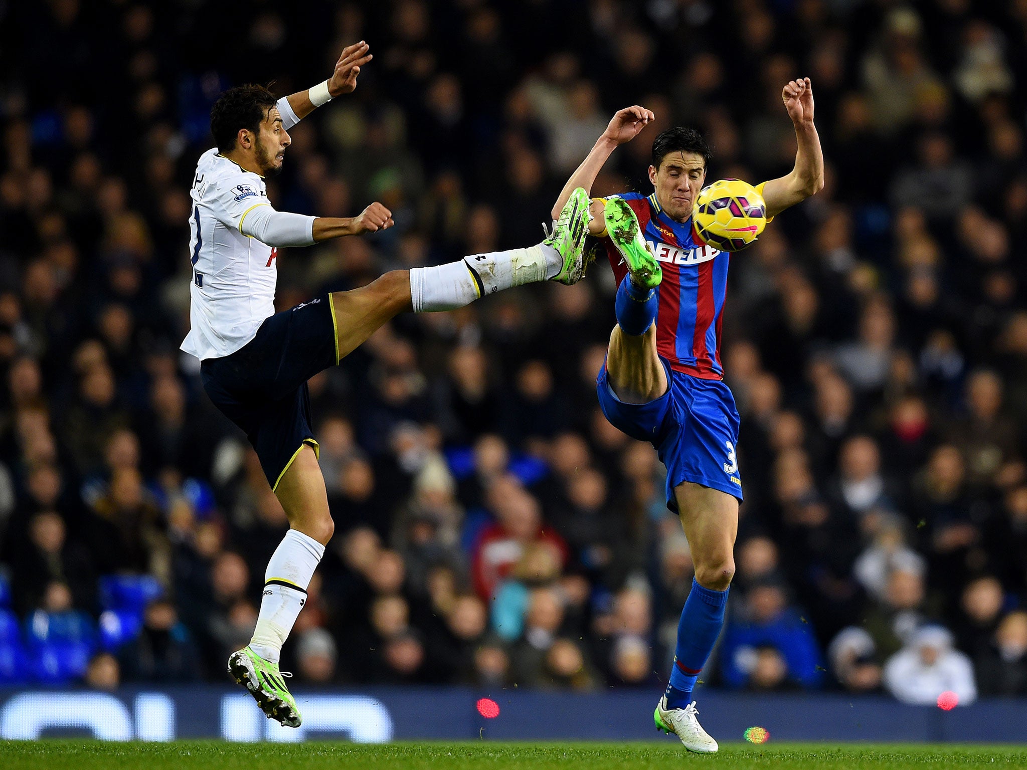 Nabil Bentaleb competes with Martin Kelly for a high ball