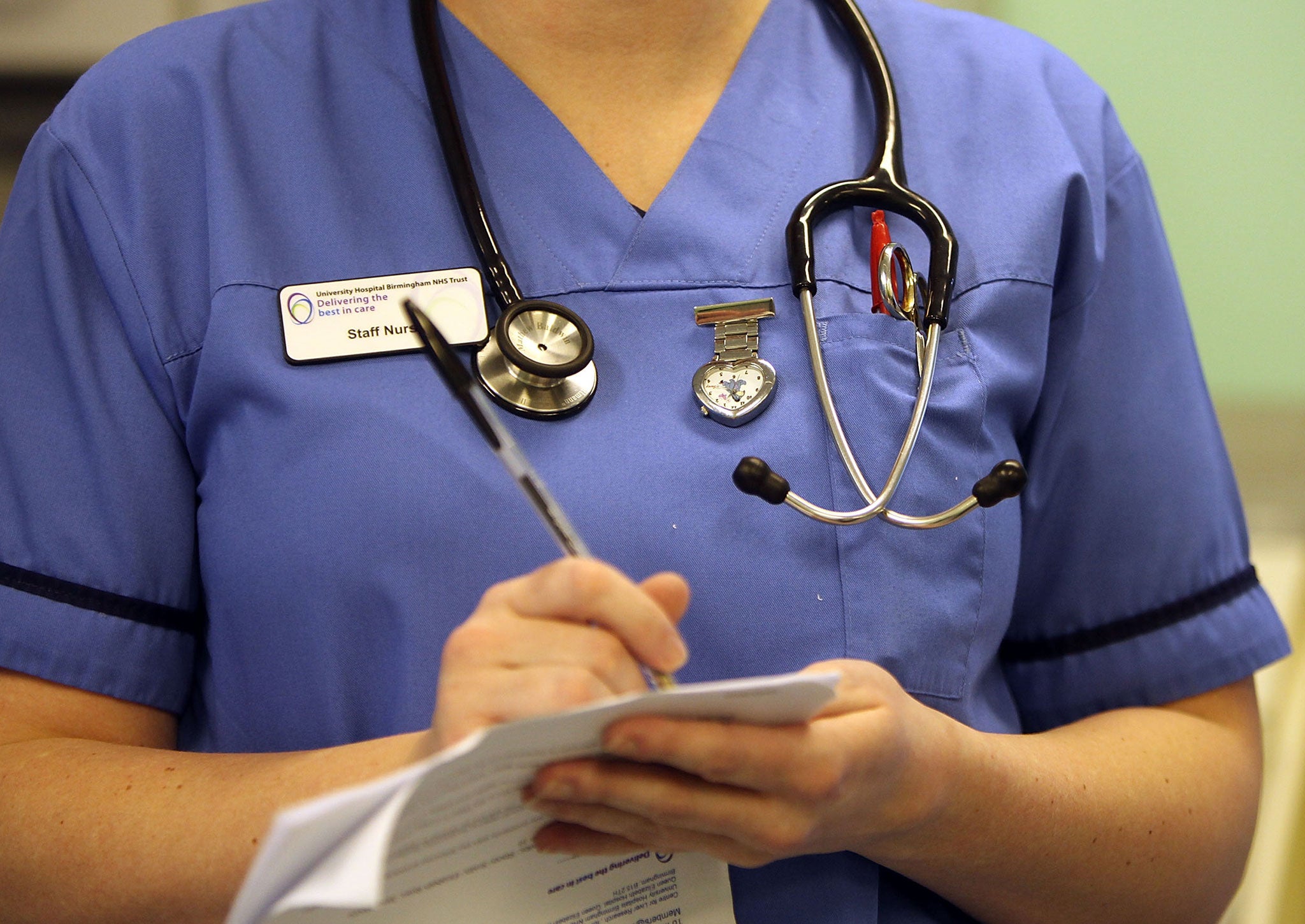 A nurse in fills out a form in the accident and emergency dept of Selly Oak Hospital