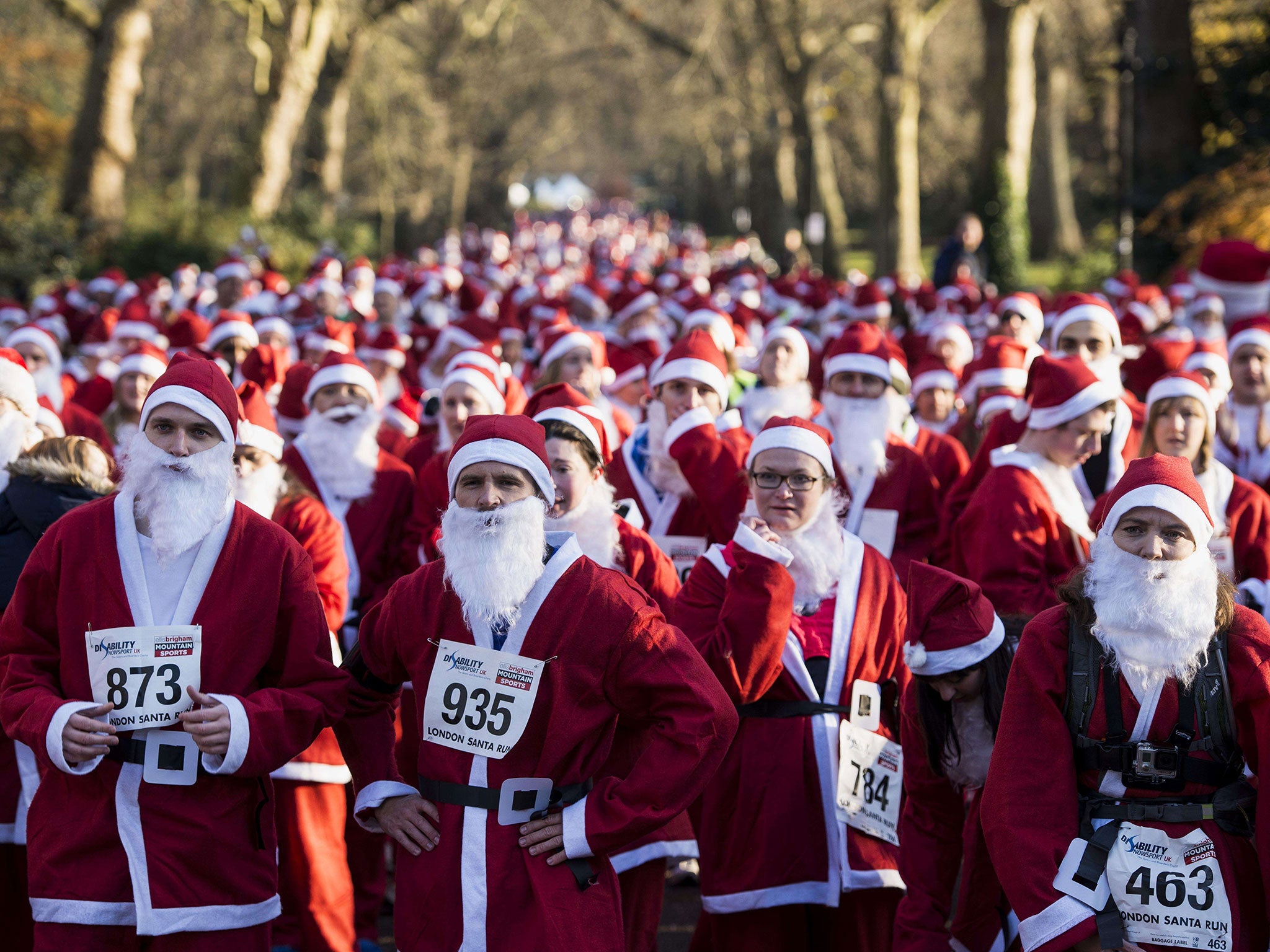 Charity runners dressed as Father Christmas await the start of the 'Santa Run' charity fun run in Battersea Park in London. Hundreds of participants dressed in Santa suits and white beards ran through Battersea park in aid of winter sports charity Disabil