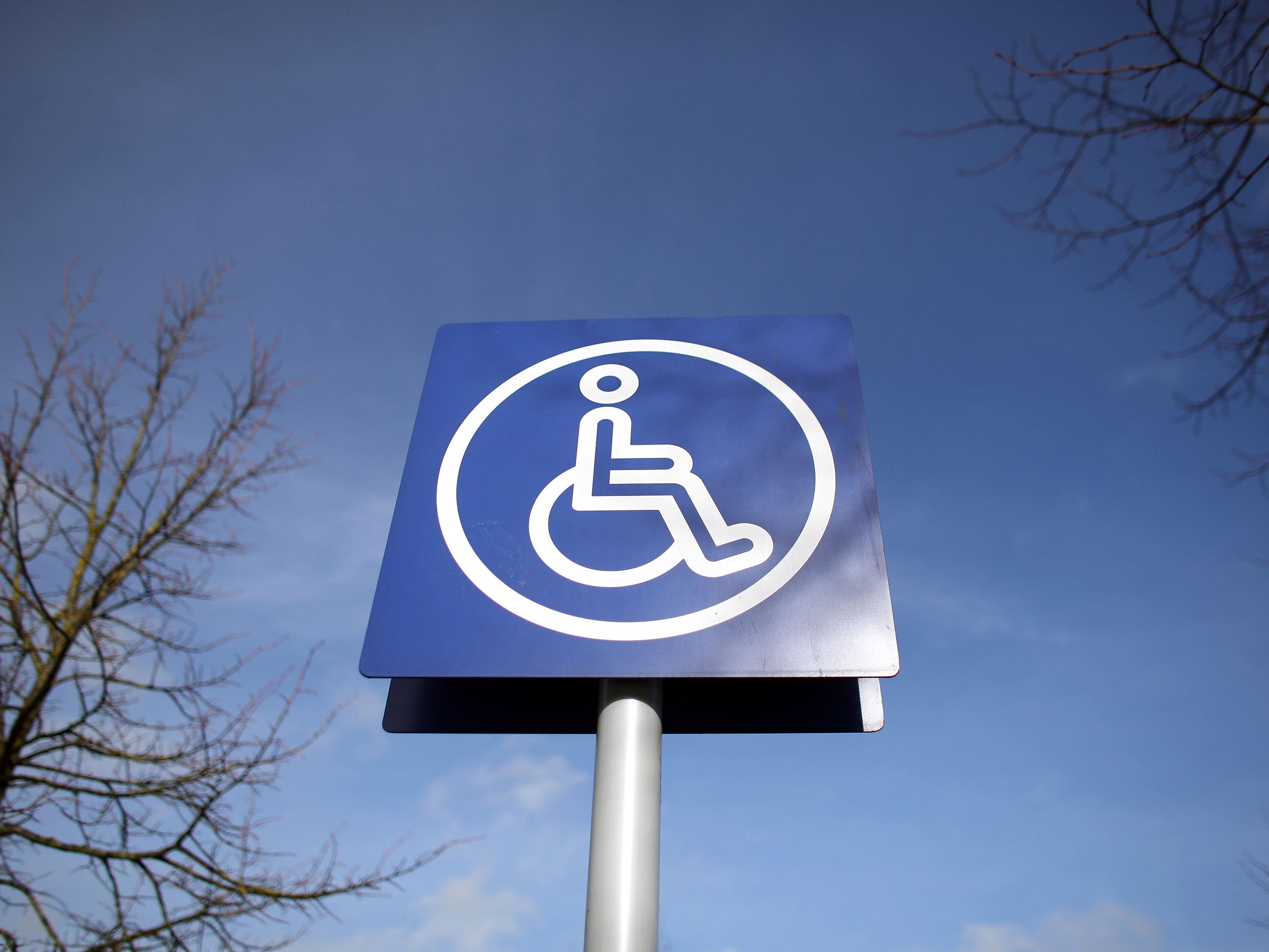 A sign is displayed above a disabled car parking bay