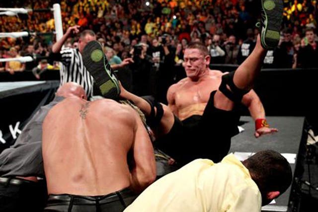 Seth Rollins throws John Cena through the announcers table