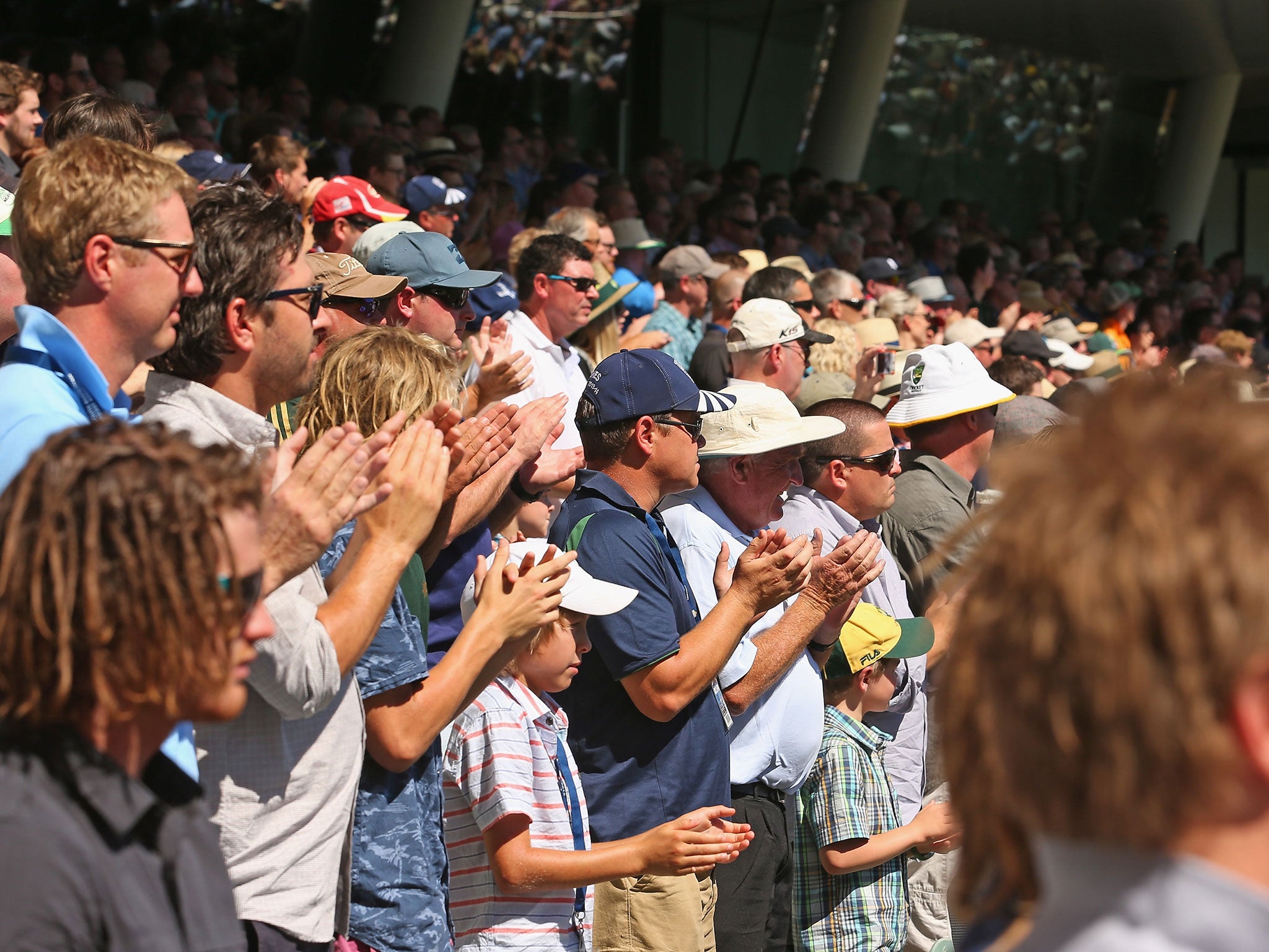 The crowd at the Adelaide Oval applaud for 63 seconds in memory of Phillip Hughes