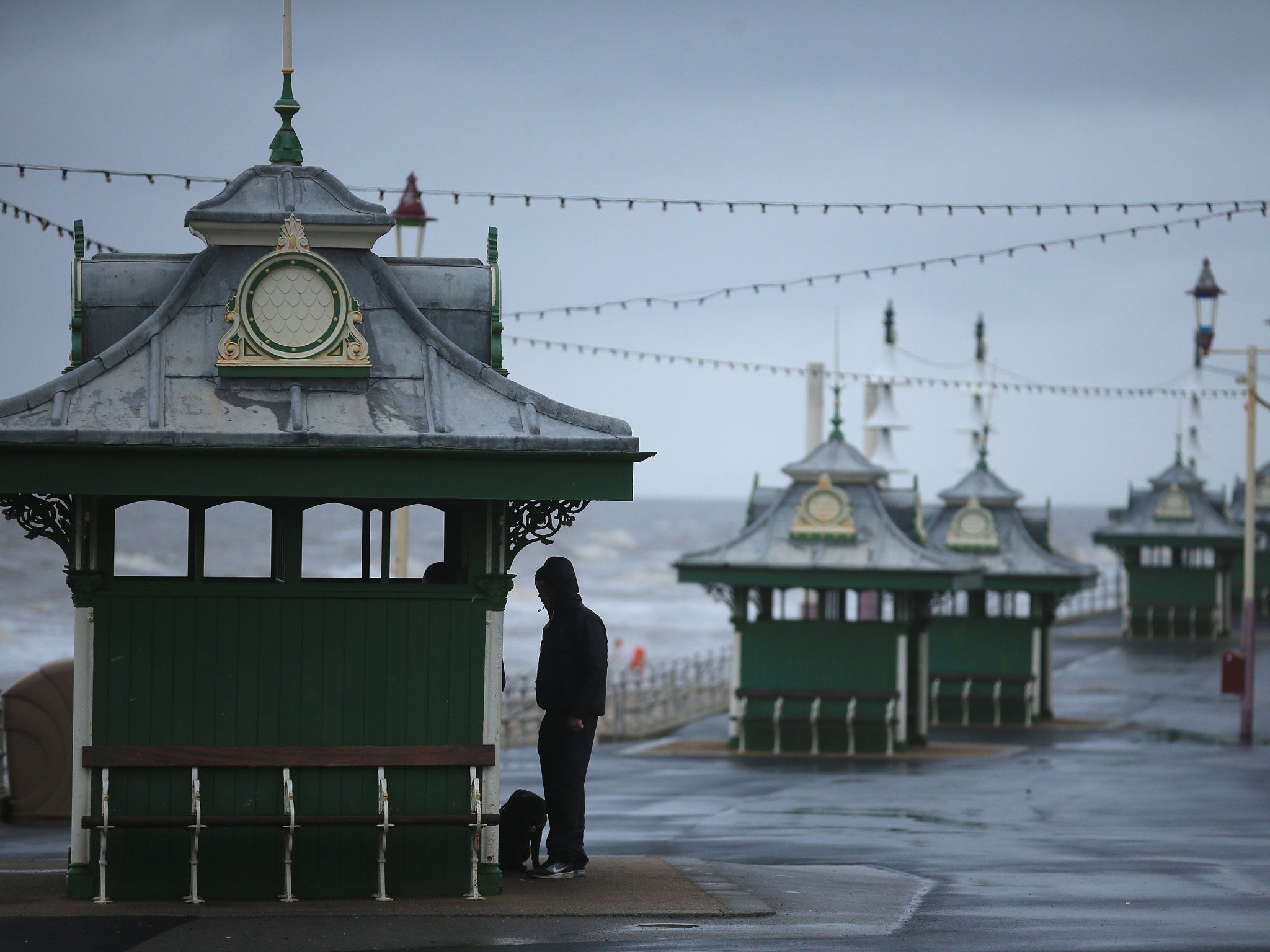 Visitors brave high winds and rain on Blackpool promenade, earlier this year. Britain is expected to be hit by another bout of stormy weather this week.