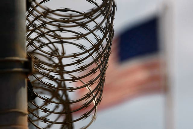 A roll of protective wire runs atop a fence in the maximum security Camp 5 at the Guantanamo Bay detention center