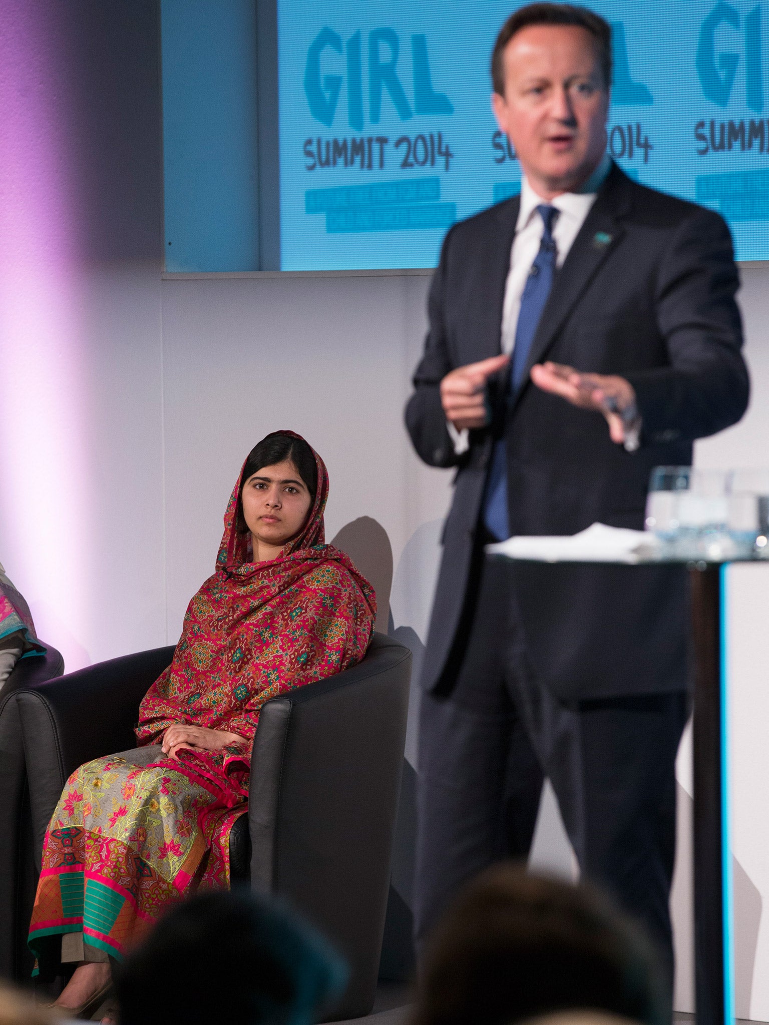 Malala Yousafzai listens to David Cameron during the 'Girl Summit 2014' in July (Getty)