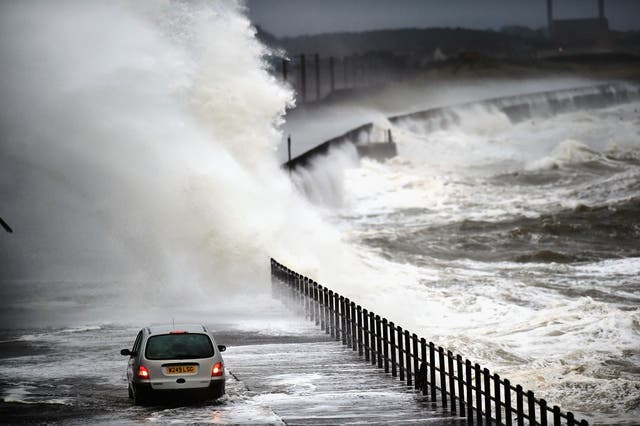 Waves crash over the promenade on in Saltcoats,Scotland