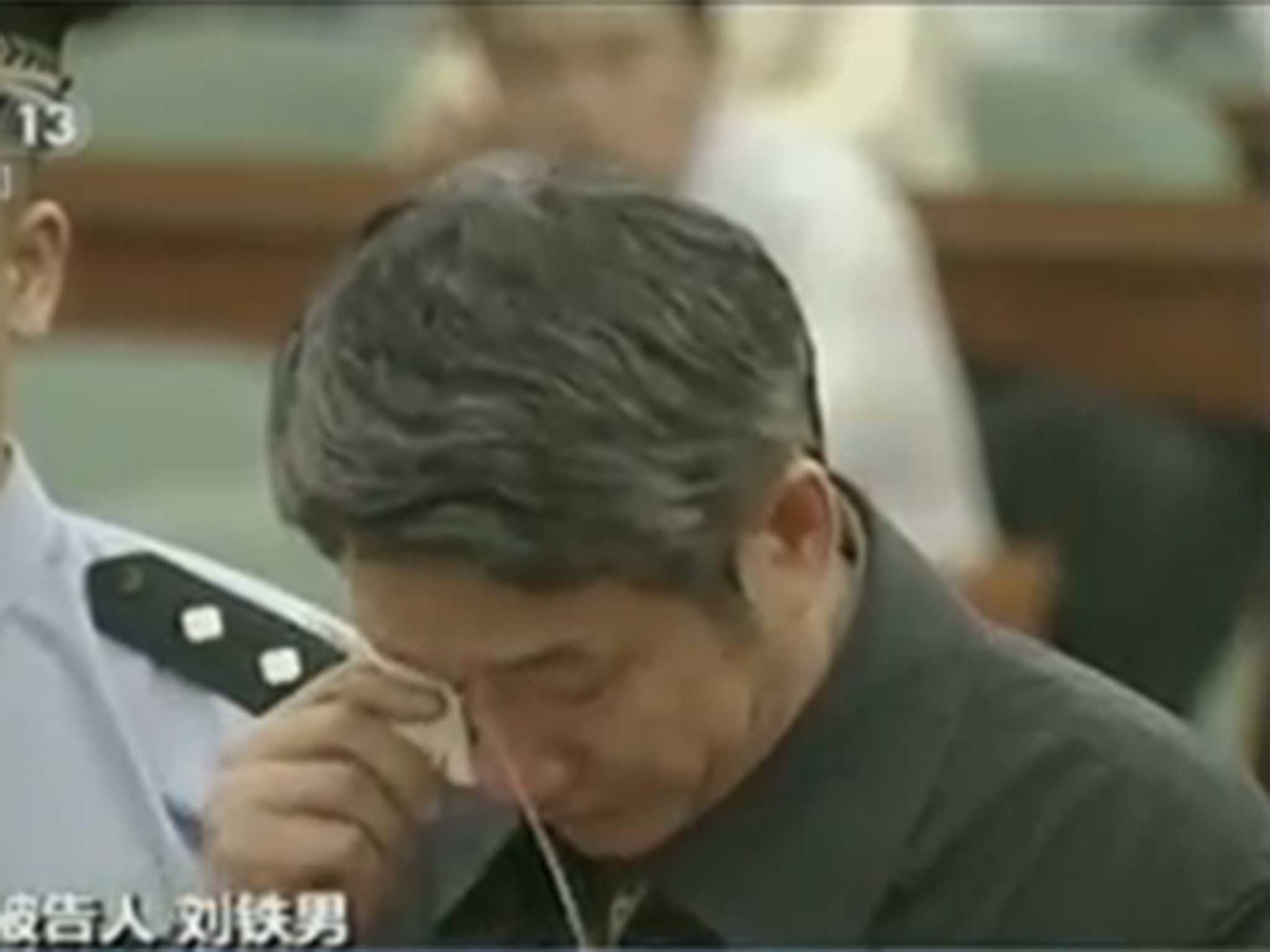 Lui Tienan dries his eyes as the judge reads his sentence