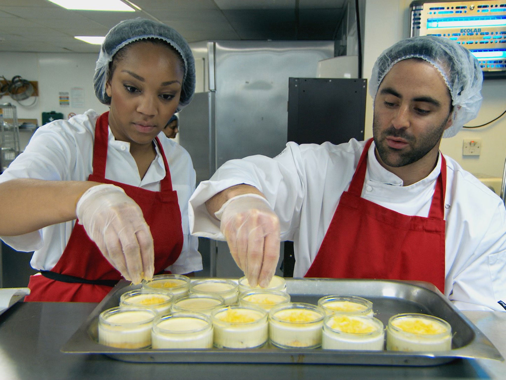 Daniel and Bianca put the finishing touches to their cheesecakes