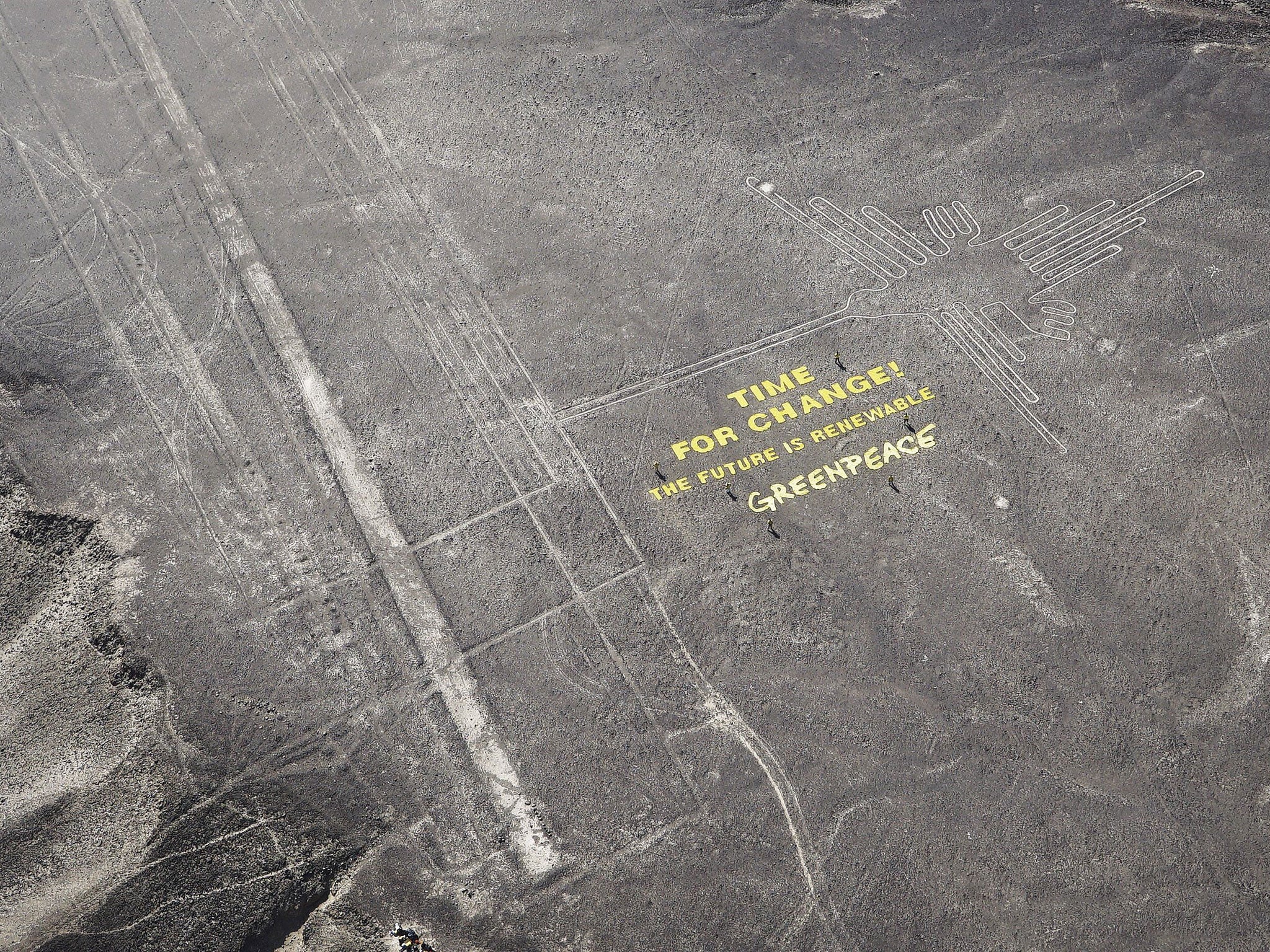 A climate change banner is seen beside the historic Nazca lines located on a stretch of coastal desert in Peru