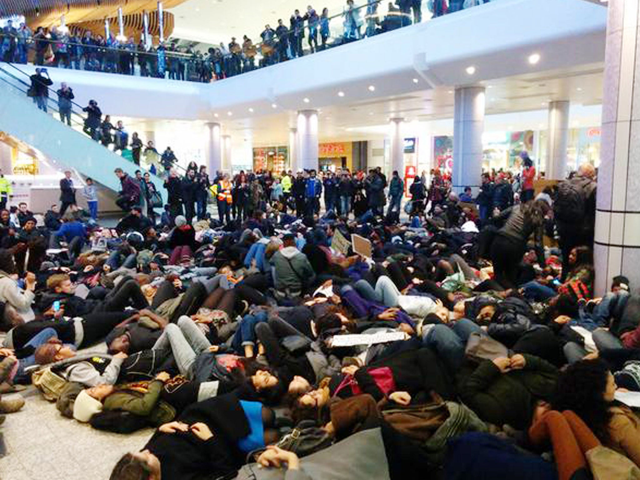 Handout photo courtesy of Areeb Ullah of protesters at Westfield Shopping Centre at Shepherds Bush as they hold a "die-in" in memory of Eric Garner