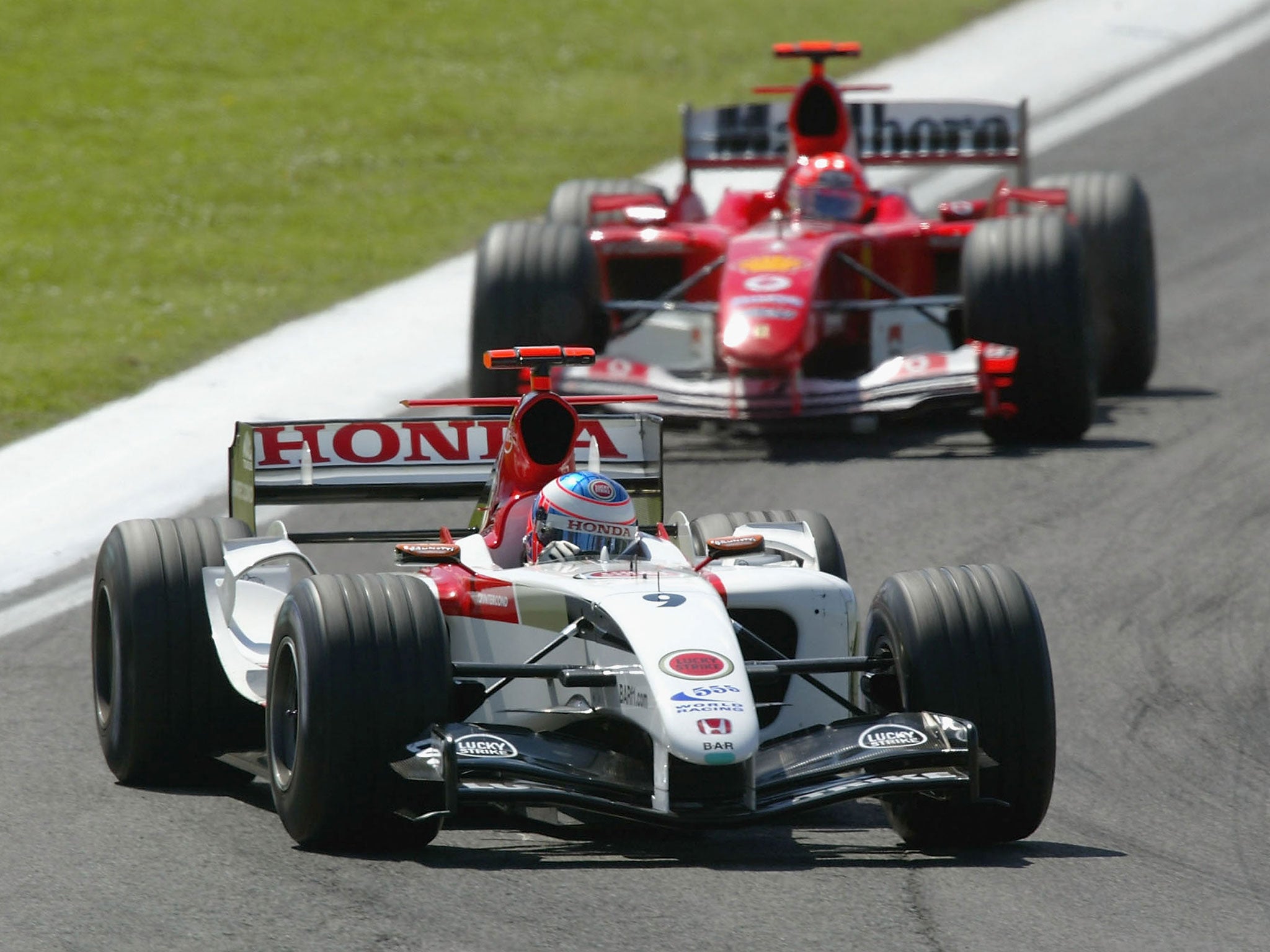 Button battles with Michael Schumacher in the 2004 San Marino Grand Prix