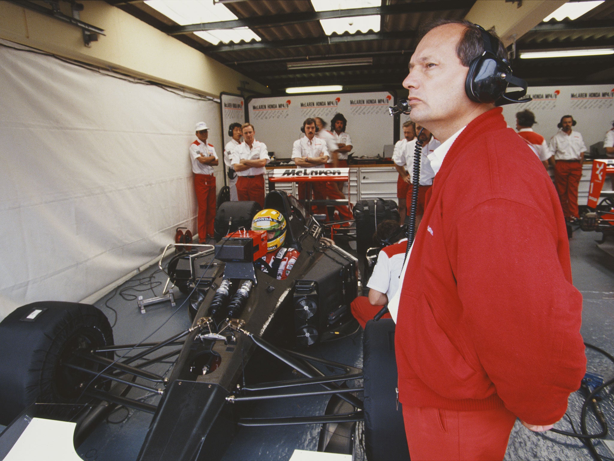Ron Dennis watches on as Ayrton Senna sits in the cockpit of the McLaren-Honda